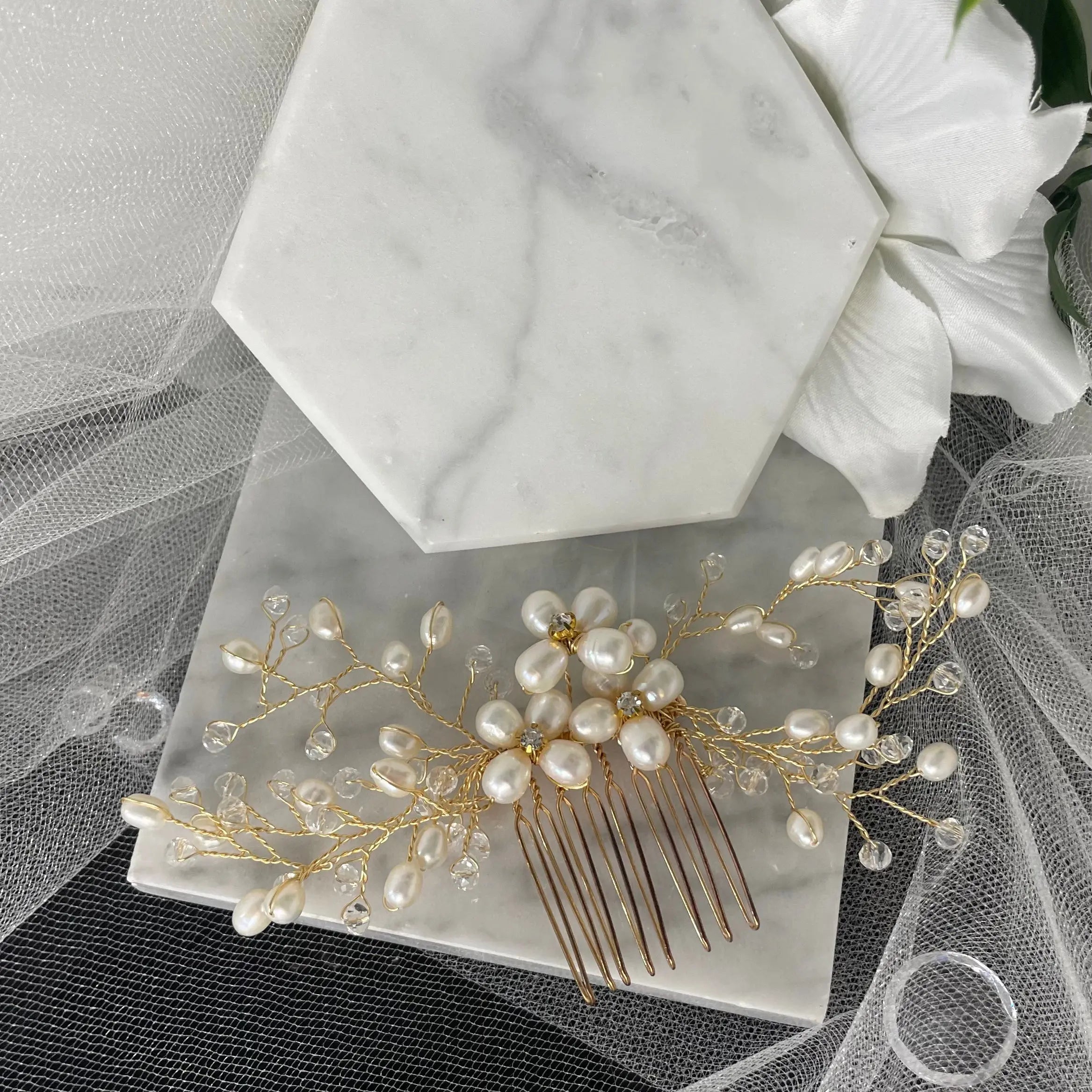 Adalynn Pearl and Crystal Wedding Comb featuring three flowers with diamanté centers and gold wiring, perfect for adding luxurious elegance to bridal hairstyles.