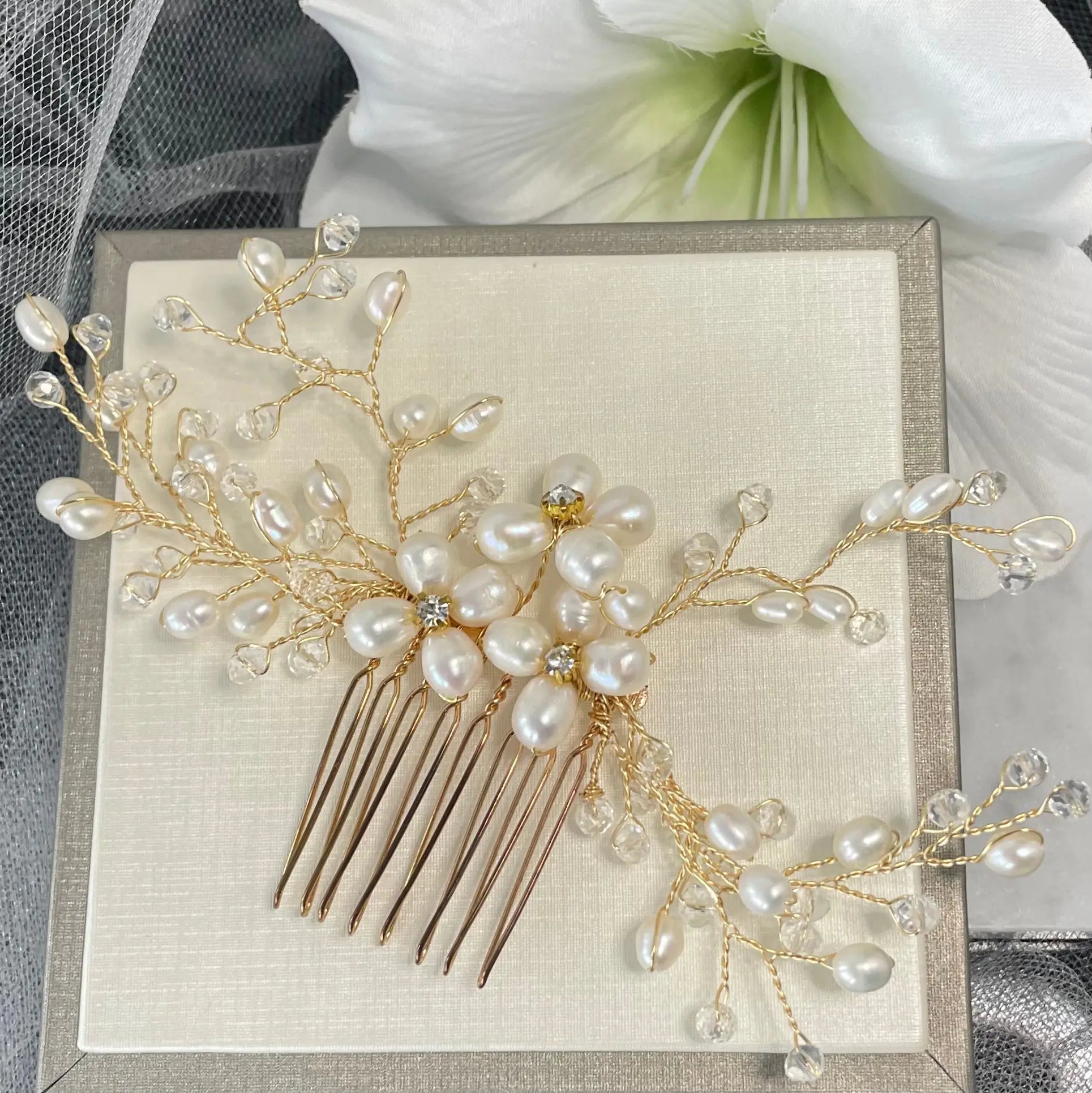 Adalynn Pearl and Crystal Wedding Comb featuring three flowers with diamanté centers and gold wiring, perfect for adding luxurious elegance to bridal hairstyles.