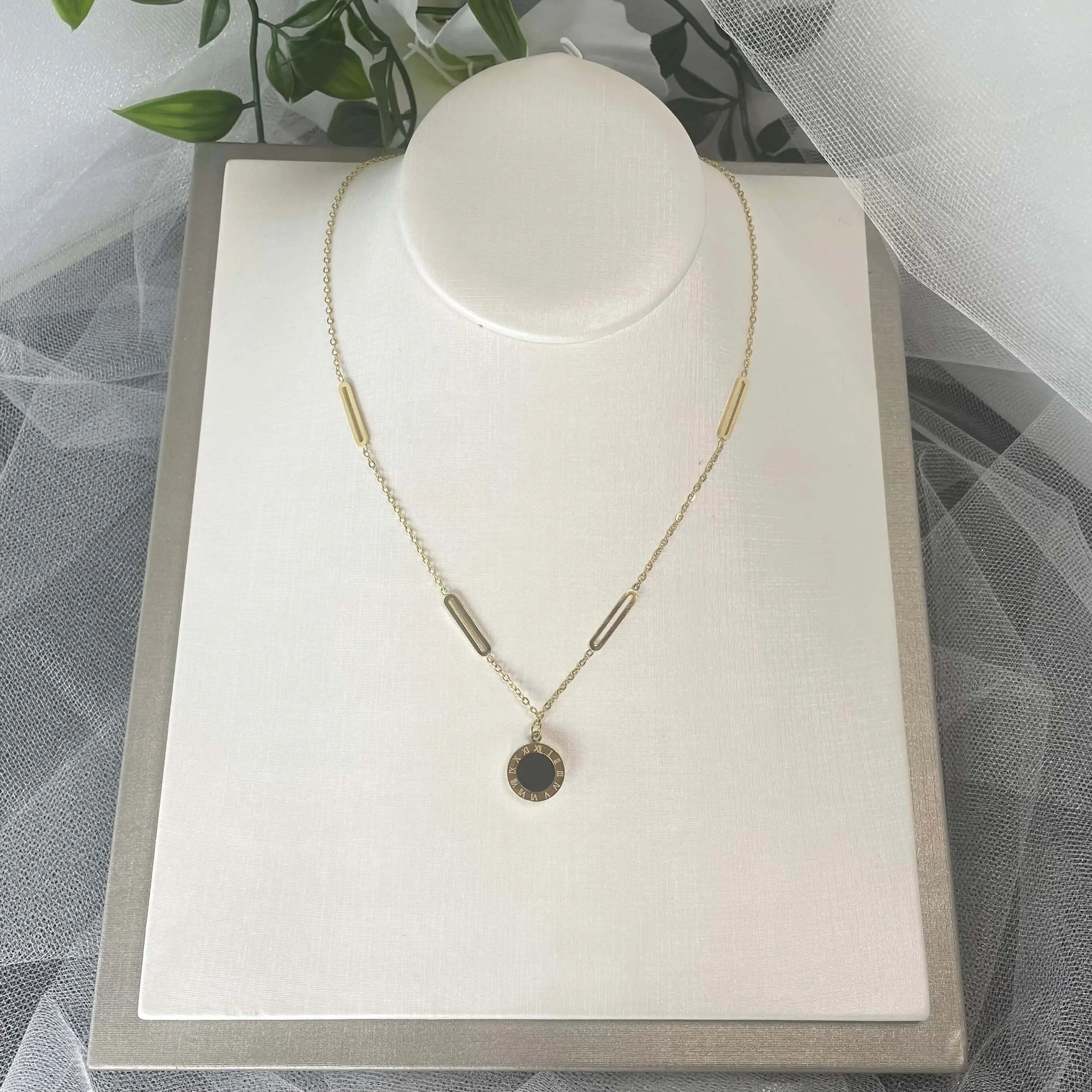 Adorn bridal necklace with reversible black & white Roman digital wafer pendant, gold accents, and stainless steel chain.