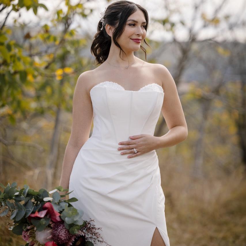 Front Close-Up Photo: Close-up of the bride in the Allure wedding gown, highlighting the sweetheart neckline and lace-beaded overlay bodice.