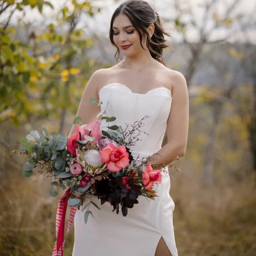 Front Close-Up Photo: Close-up of the bride in the Allure wedding gown, highlighting the sweetheart neckline and lace-beaded overlay bodice.
