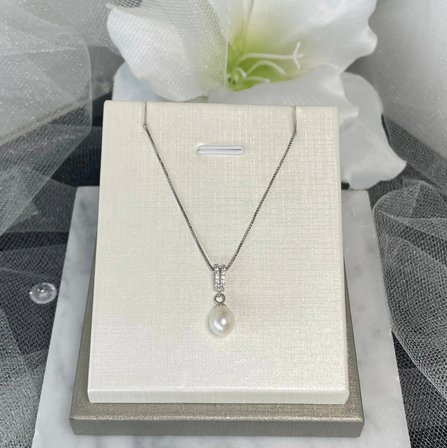 Allyn Earring and Necklace Pearl Set featuring two straight lines of sparkling crystals that drop into a lustrous pearl pendant, with a 45 cm chain, perfect for formal events and everyday wear.