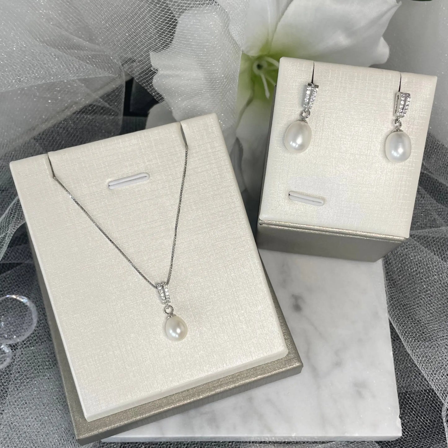 Allyn Earring and Necklace Pearl Set featuring two straight lines of sparkling crystals that drop into a lustrous pearl pendant, with a 45 cm chain, perfect for formal events and everyday wear.