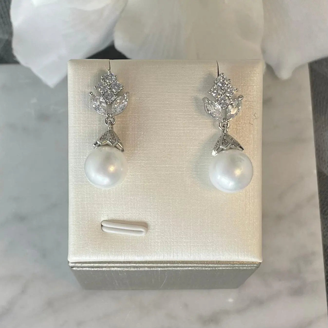 Aloes Pearl Bridal Earrings featuring a flower design with princess-cut cubic zirconia and a lustrous freshwater pearl, crafted from high-quality copper with 18k gold or silver plating, perfect for weddings and special occasions.