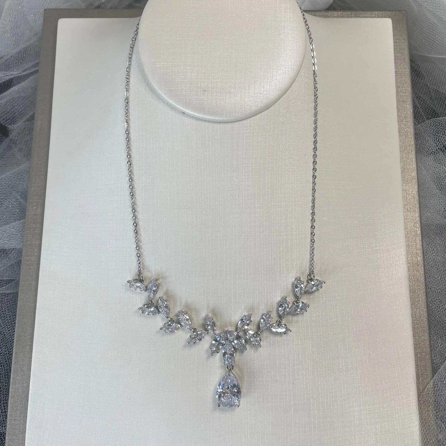 Silver Necklace: An elegant silver necklace with a delicate leaf design and a stunning diamante drop.