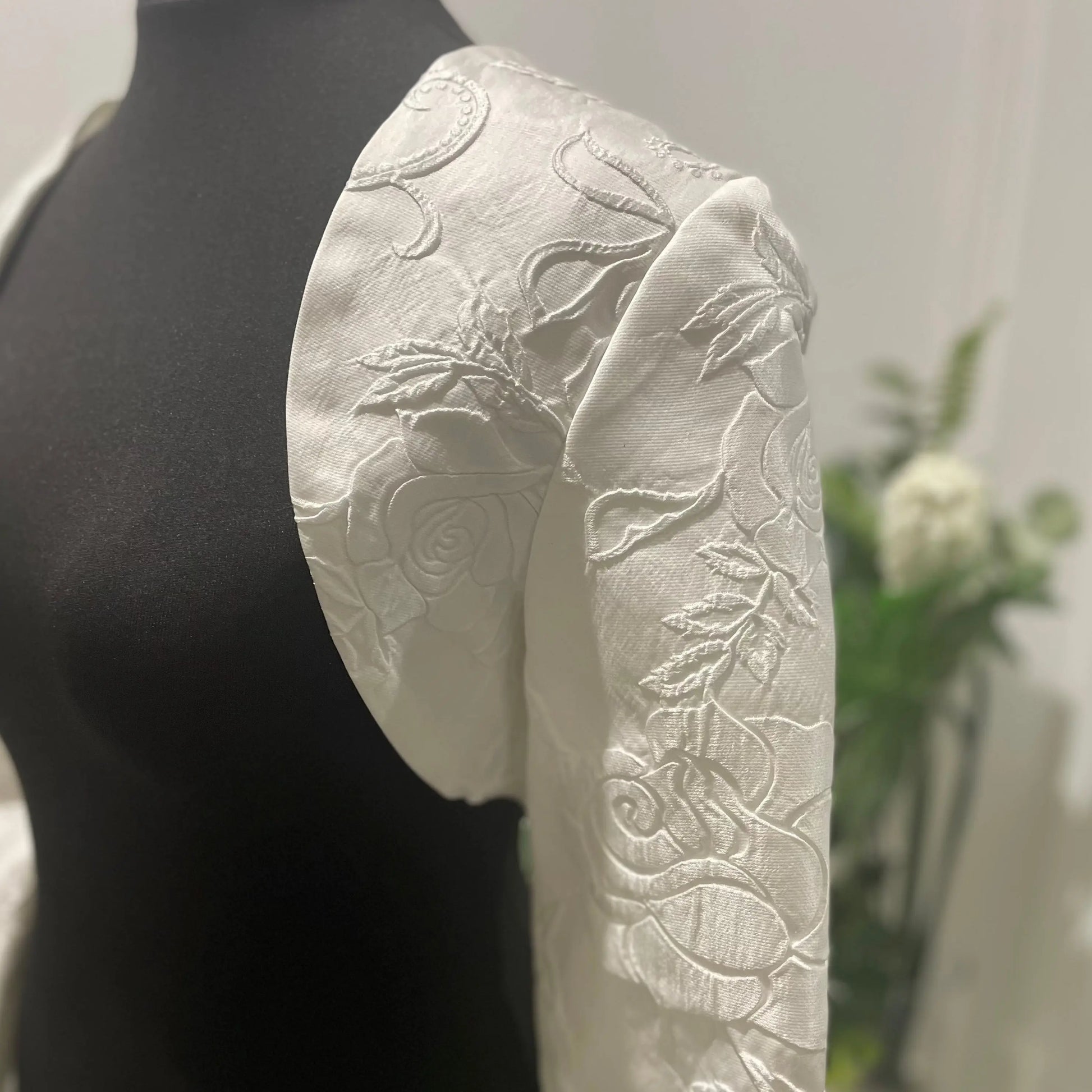 Side view of luxurious Charoite silk bolero jacket, perfect for enhancing any bridal gown with its exquisite 3D texture