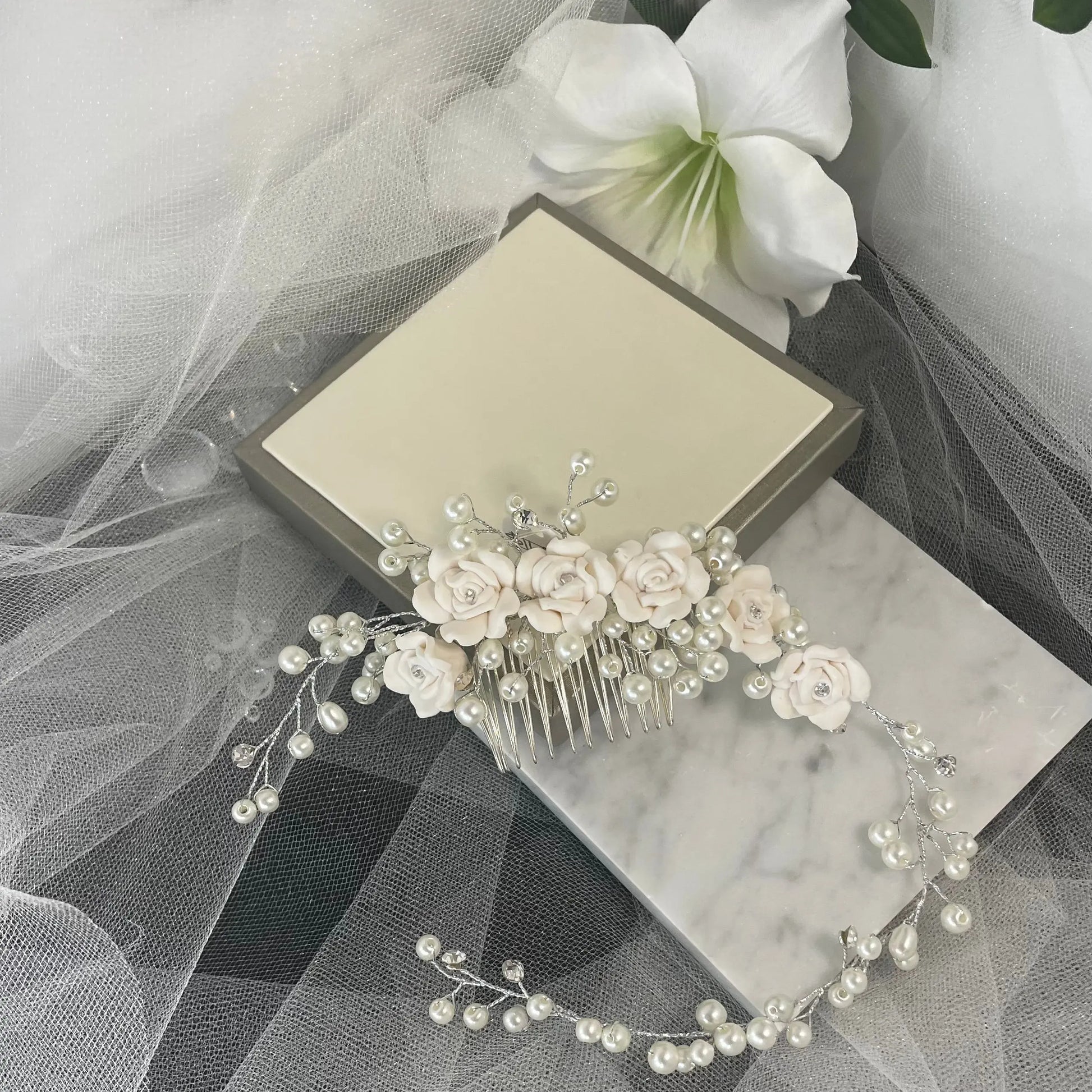 Stunning Clara Hair Vine by Divine Bridal, adorned with delicate flowers, sparkling Diamantés, and pearls, elegantly designed to enhance bridal hairstyles with sophistication.