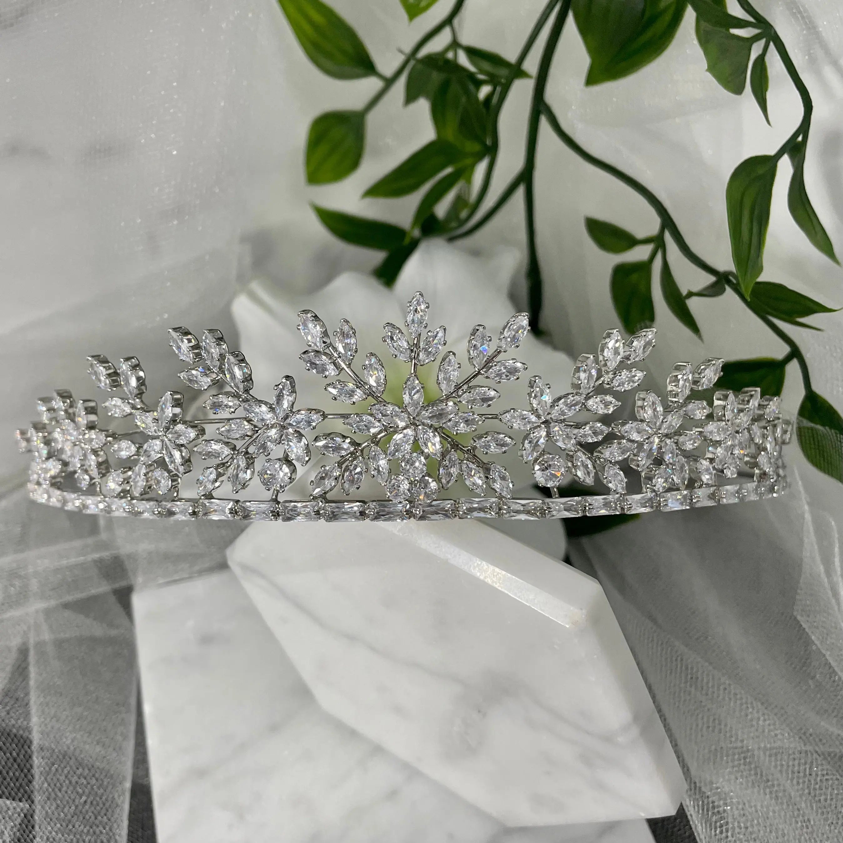 Darcy Bridal Tiara, featuring an exquisite floral and leaf design in silver, enhances bridal elegance with its intricate detailing and captivating sparkle.