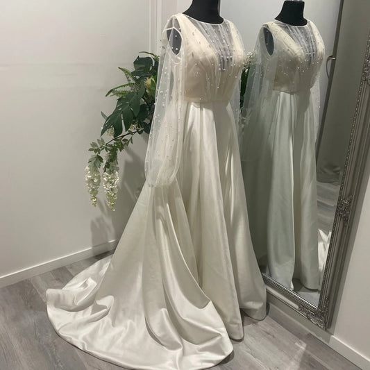 Front view of the Darcy bridal topper featuring pearl tulle with elegant front draping and mutton sleeves, perfect for sophisticated bridal wear.