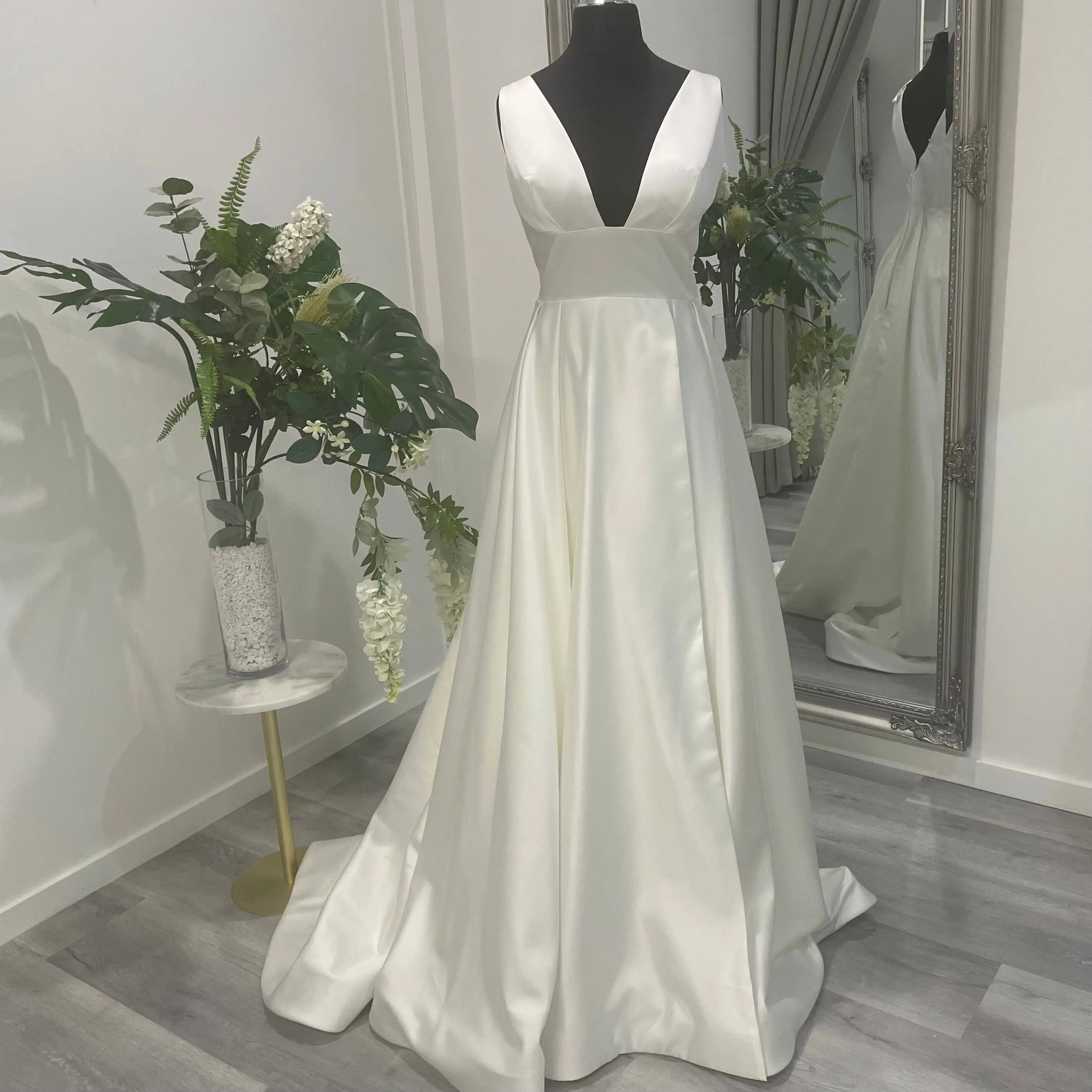 Elegant Darcy Wedding Dress with front skirt split on display at Divine Bridal.