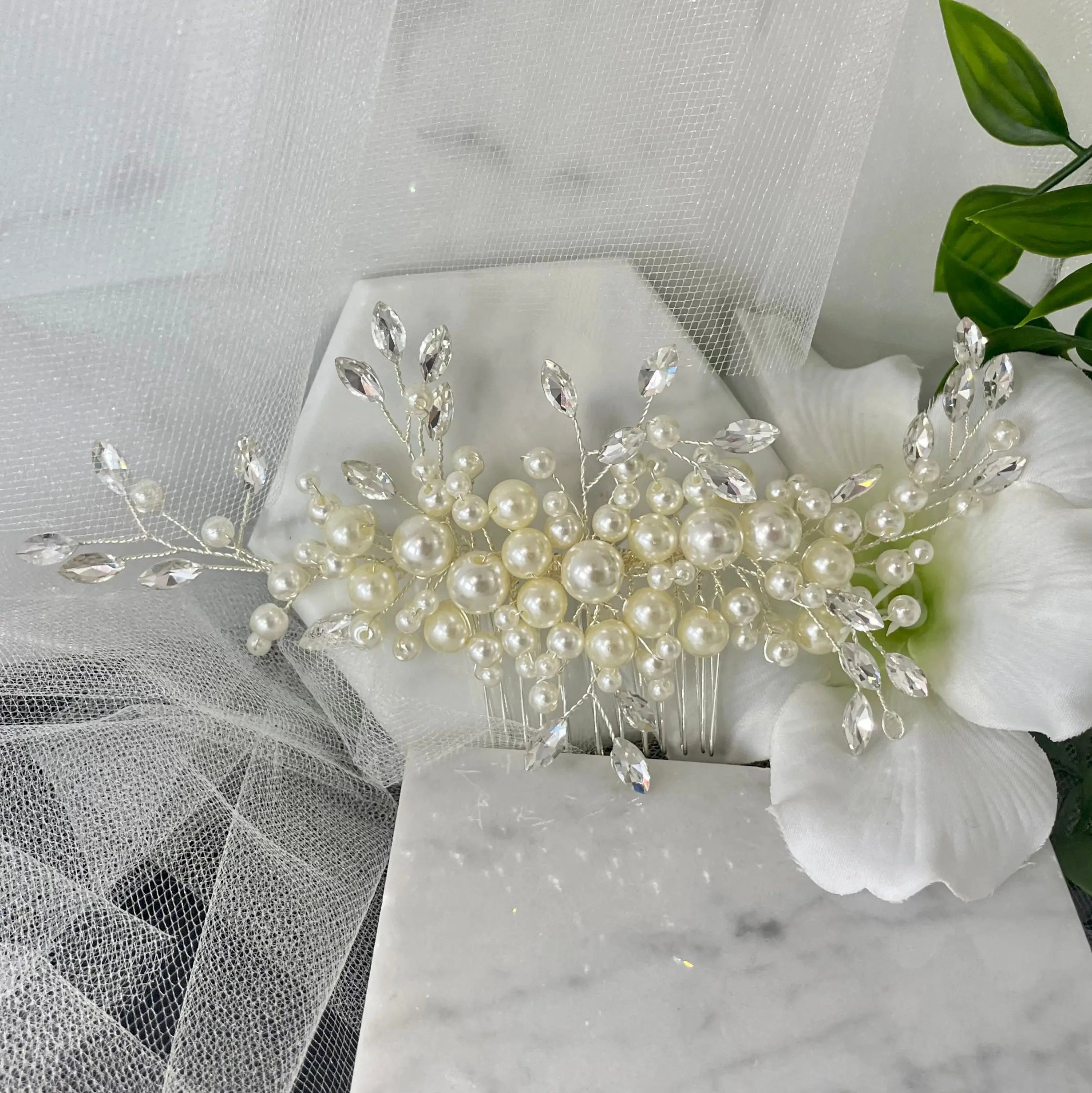 Handcrafted Dina Bridal Hair Comb featuring a blend of pearls and diamanté in a leaf design, set on a silver comb, ideal for adding elegance and class to any bridal hairstyle.