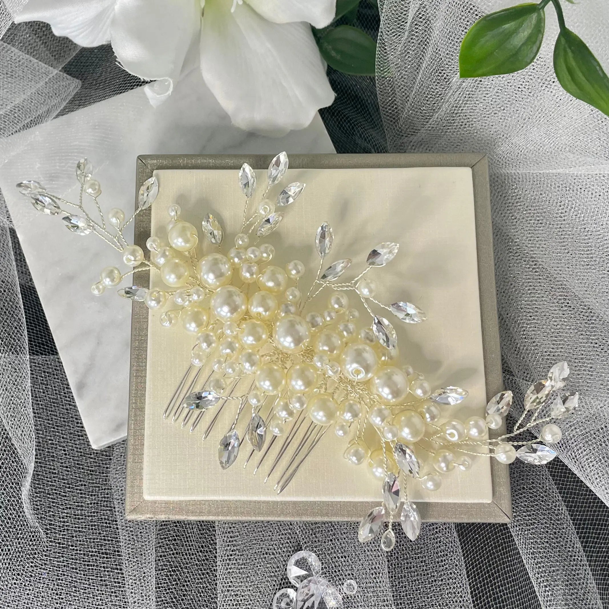 Handcrafted Dina Bridal Hair Comb featuring a blend of pearls and diamanté in a leaf design, set on a silver comb, ideal for adding elegance and class to any bridal hairstyle.