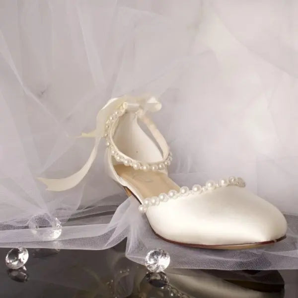 Dixie Bridal Shoe Single Side Front View: Side front view of one Dixie Pearl Closed Toe Ankle Strap Wedding Bridal Shoe highlighting the elegant closed toe and satin bow detail.
