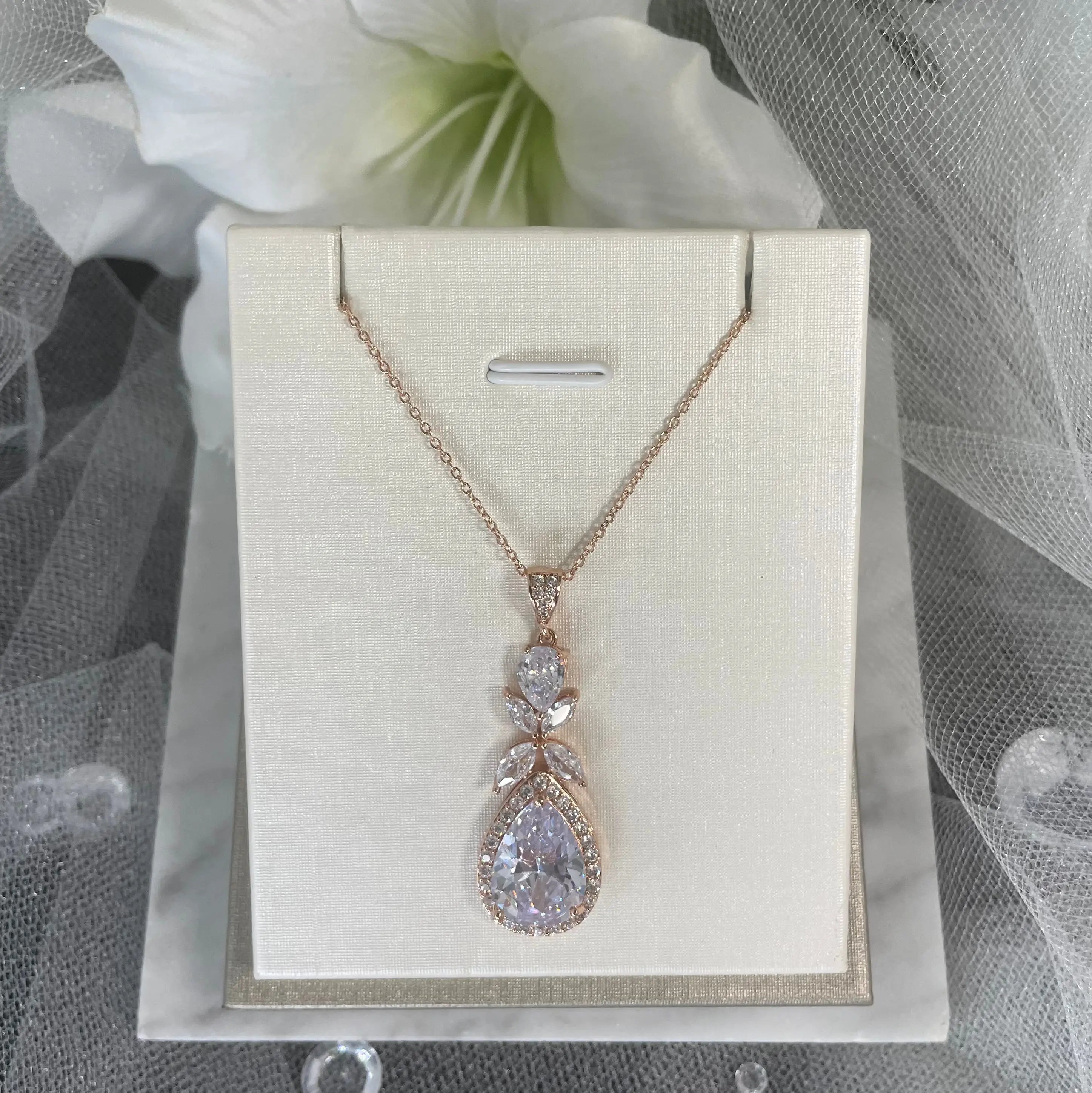 Ela Pendant Necklace (Close-Up - Rose Gold): A close-up view of the Ela Pendant Necklace in rose gold, showcasing the sparkling cubic zirconia and elegant tear drop design.