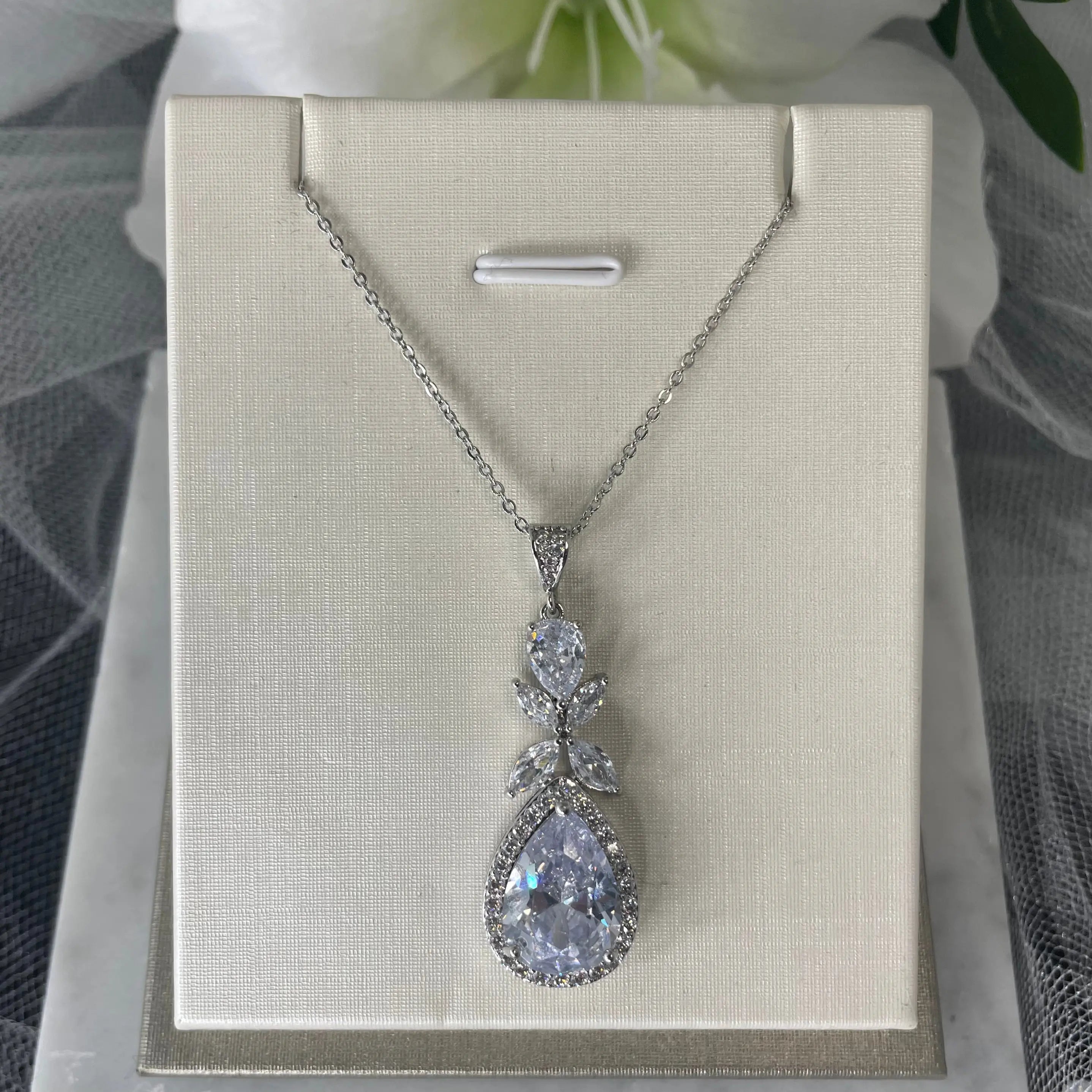 Ela Pendant Necklace (Close-Up): A close-up view of the Ela Pendant Necklace showcasing its sparkling cubic zirconia and elegant tear drop design.