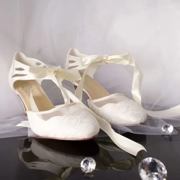 Elise Bridal Shoe Pair Side View: Side view of two Elise Lace Closed Toe Ankle Strap Wedding Bridal Shoes showcasing the floral lace and satin tie.