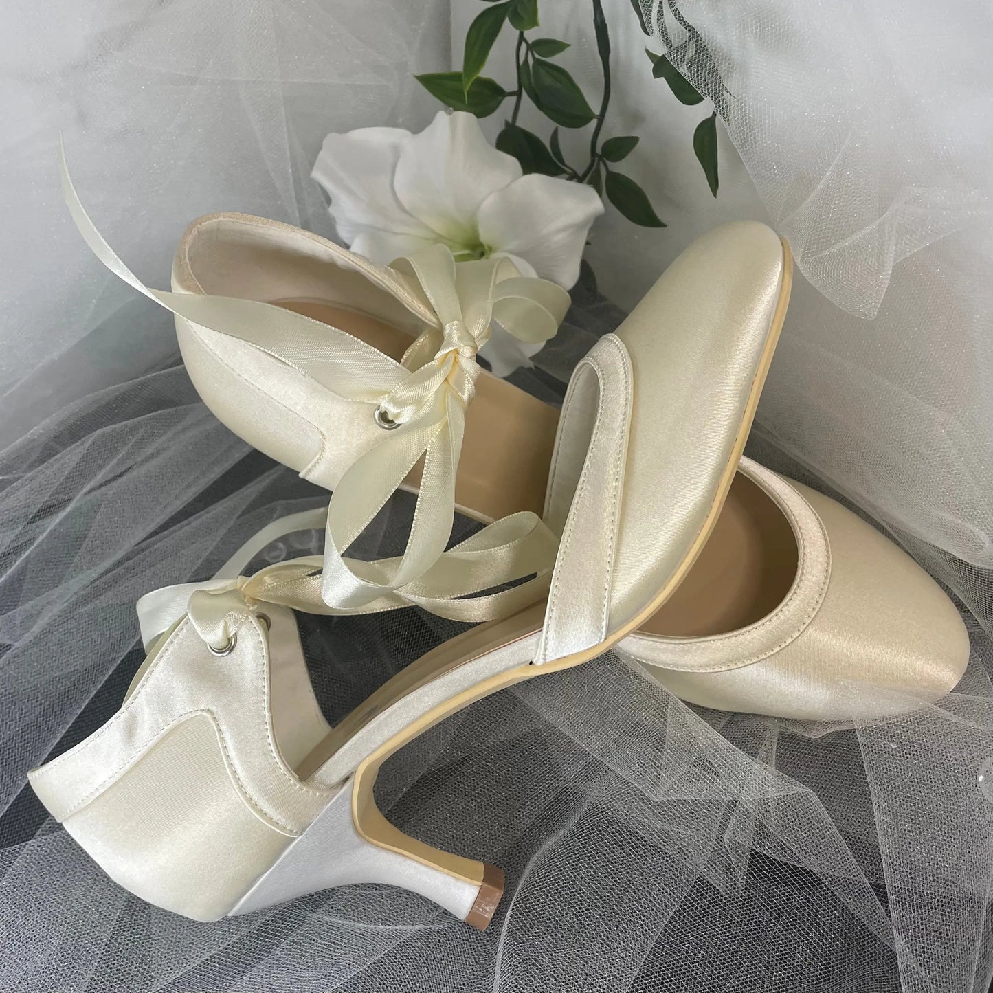 Ellie Bridal Shoe Pair Side and Front View Different Color: Side and front view of two Ellie Closed Toe Ribbon Ankle Strap Wedding Bridal Shoes showing the slight color difference due to display stock.