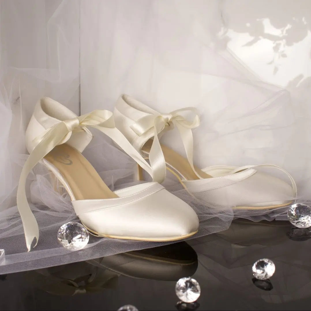 Ellie Bridal Shoe Pair Side View: Side view of two Ellie Closed Toe Ribbon Ankle Strap Wedding Bridal Shoes showcasing the satin overlay and ribbon ankle strap.