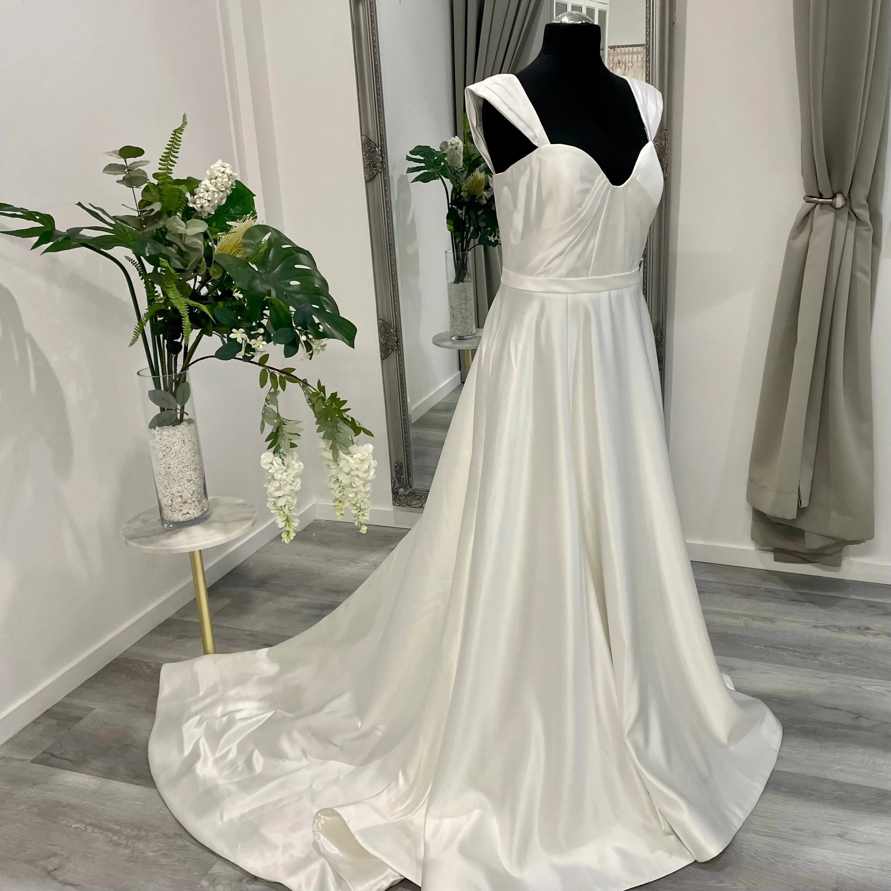 An elegant wedding dress from Divine Bridal A-Line Sweetheart gown, featuring exquisite detailing and a flowing chapel train.