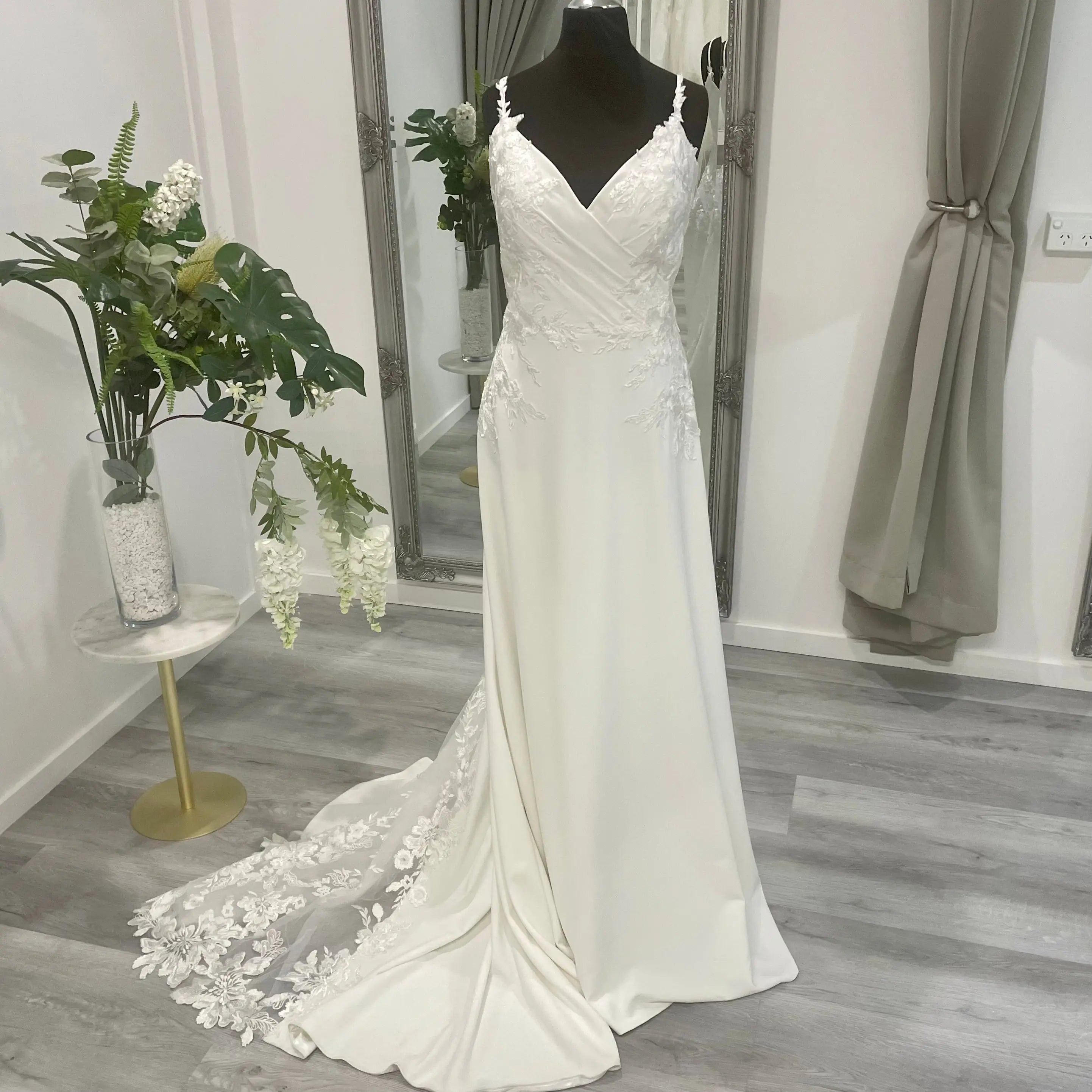 Harlow Wedding Dress with lace detailing and V-neckline on display at Divine Bridal salon.