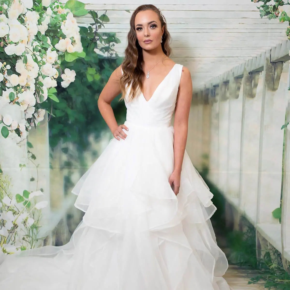 Gabriella bridal dress with a V-neckline and layered organza skirt.