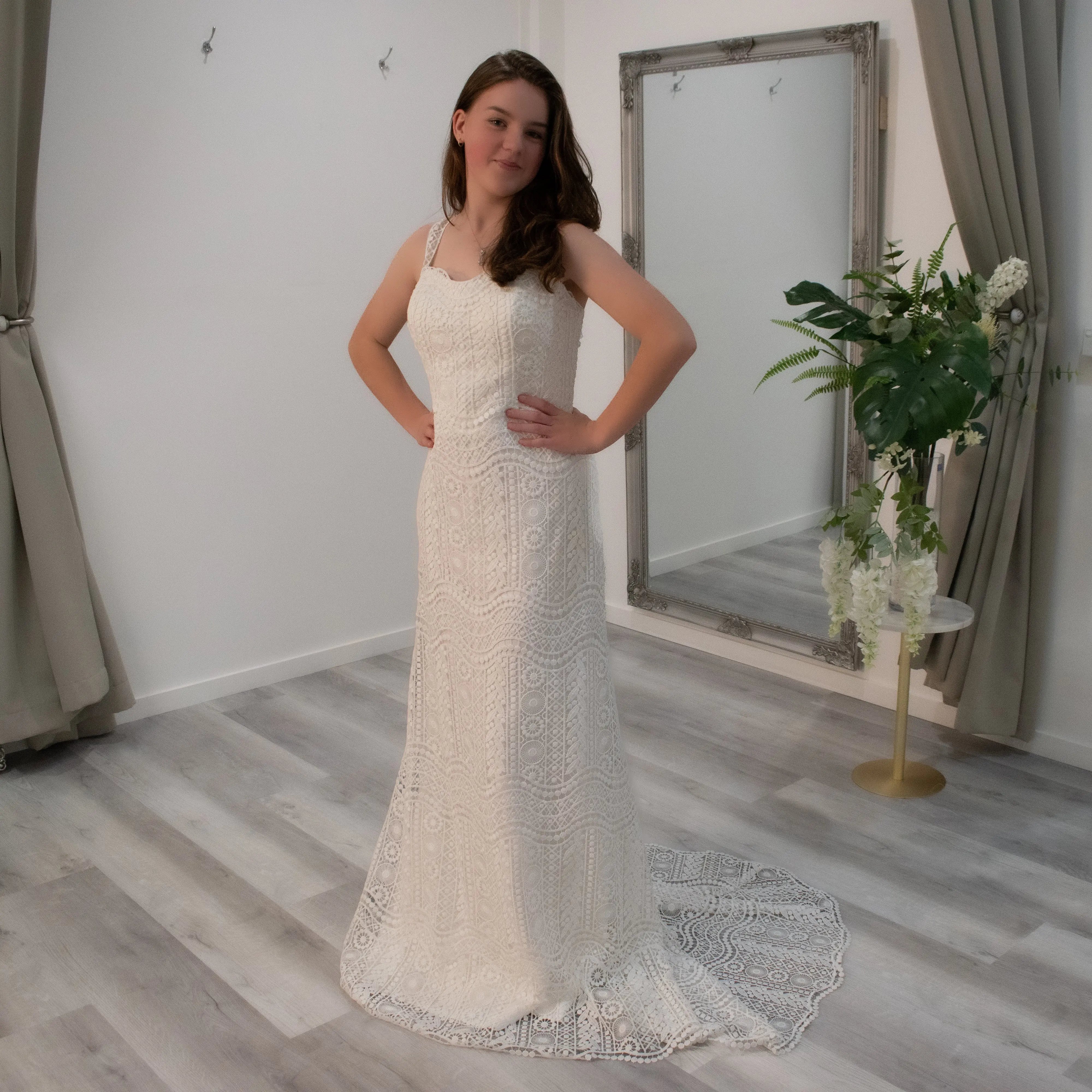 Bride adorned in Gwen Boho-inspired wedding gown, highlighting the wave lace design, sweetheart swirl neckline, and elegant train.