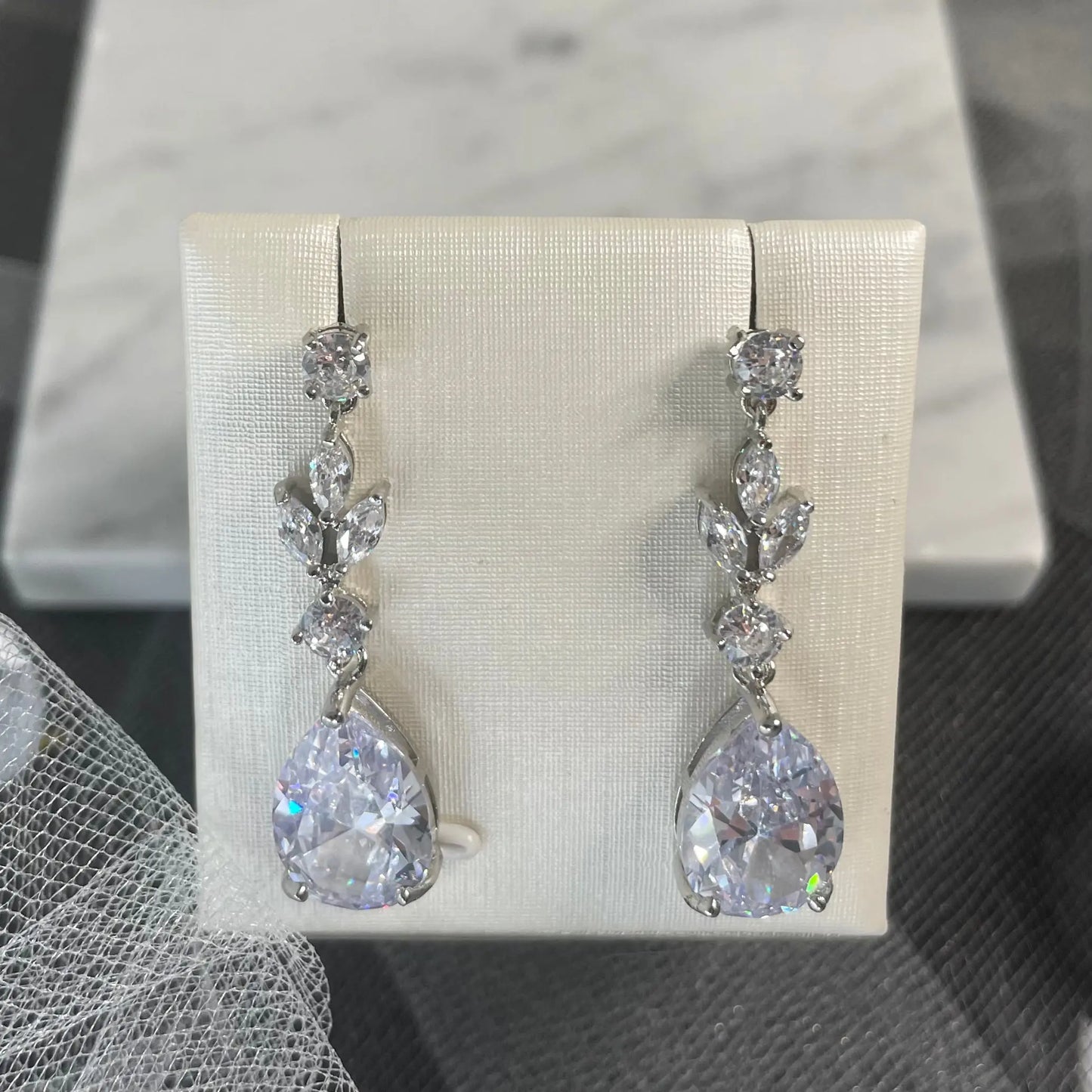 Hana Water Drop Bridal Wedding Earrings: A pair of elegant water drop bridal wedding earrings, featuring AAA zircon stones and available in white gold, gold, and rose gold plating.