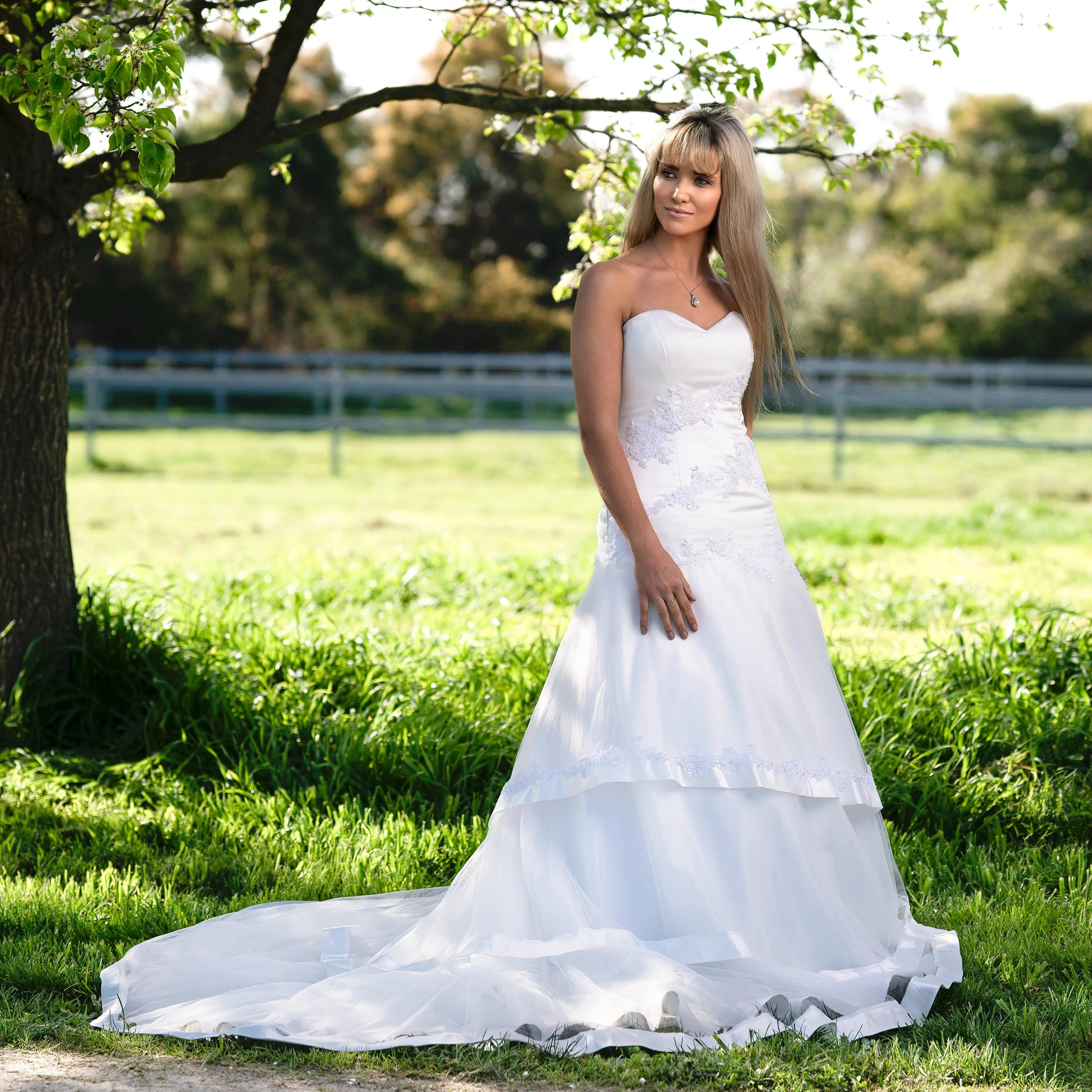 Hazel Bridal Gown Side View: Side view of the 'Hazel' Gown, highlighting the intricate lace details and mermaid silhouette.