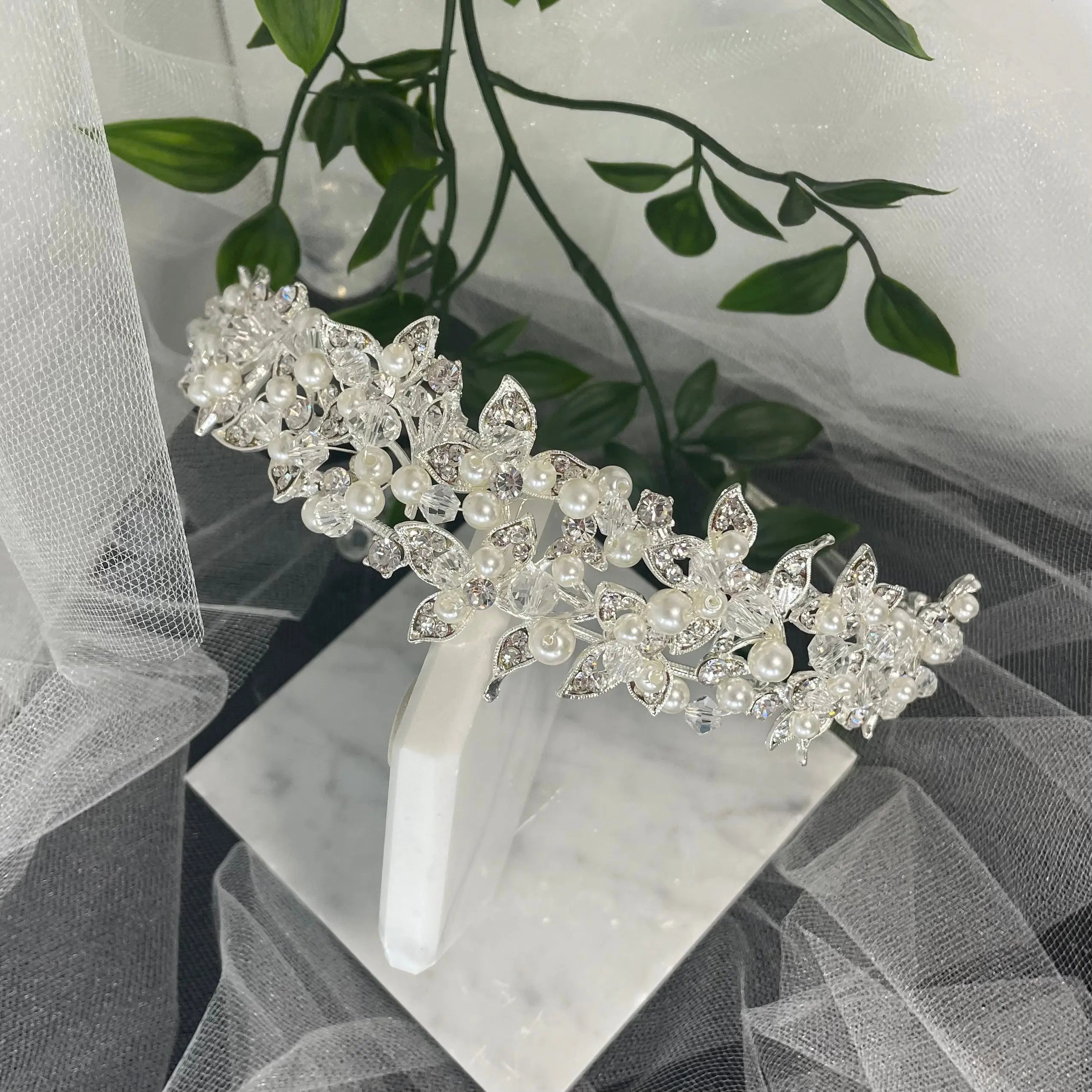 Exquisite Iris Bridal Headpiece with a floral design, adorned with pearls, crystals, and Diamontes, ideal for enhancing a sophisticated bridal hairstyle.