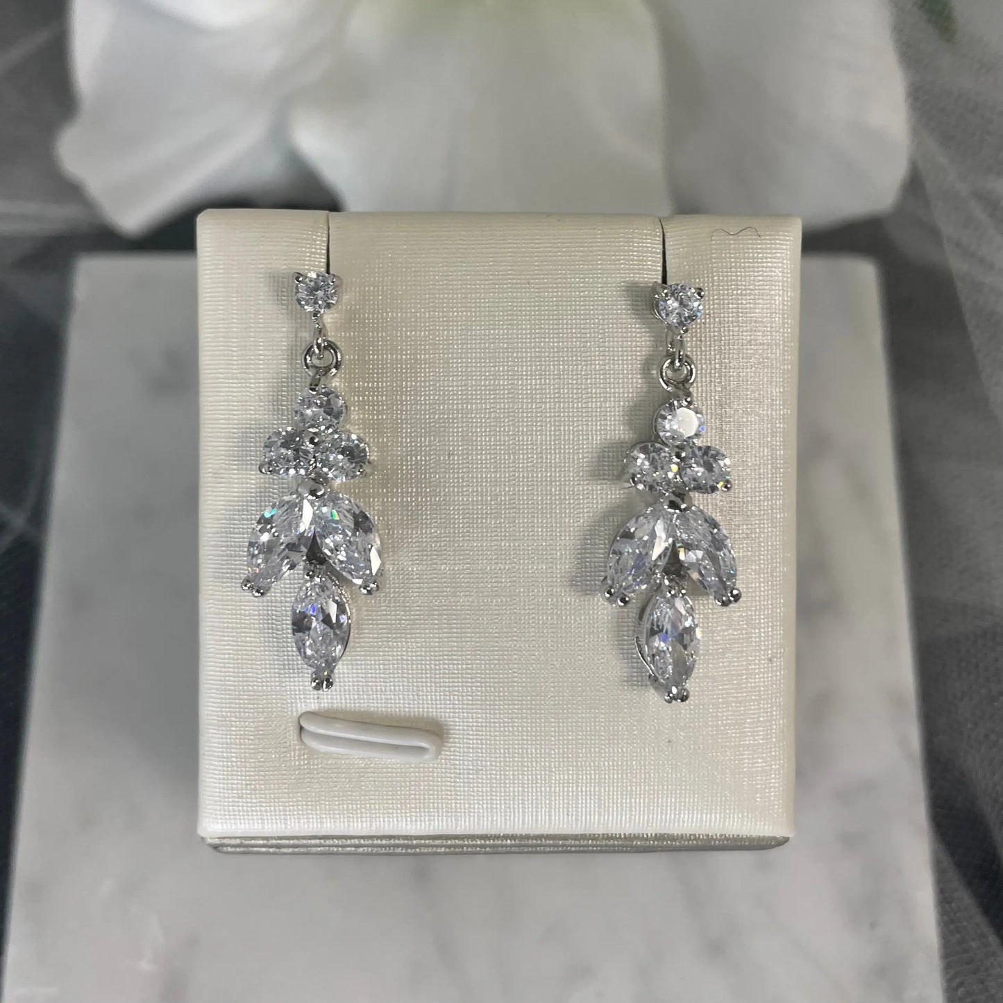 Silver Earrings: Sophisticated silver earrings with a leaf and flower design and clear cubic zirconia.
