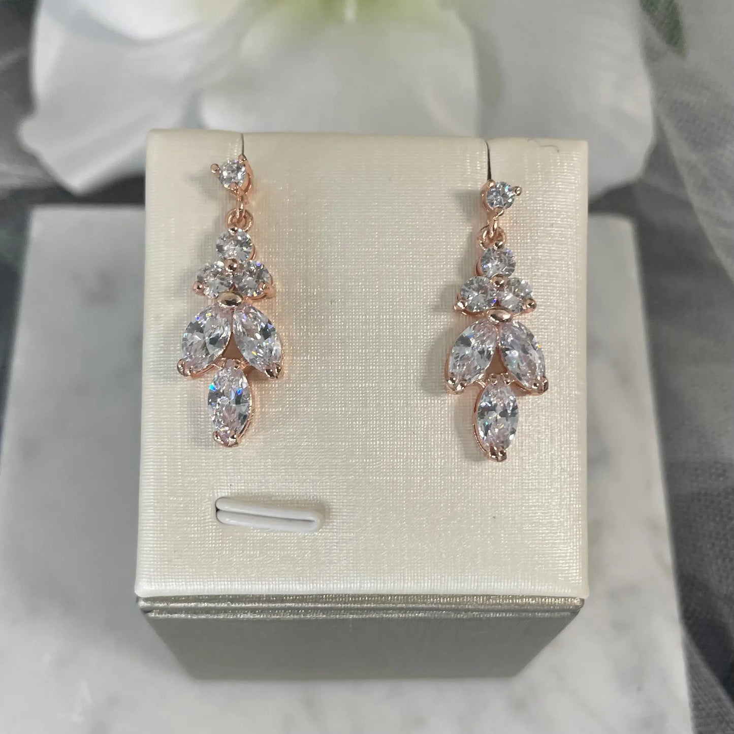 Rose Gold Earrings: Elegant rose gold earrings featuring a leaf and flower design with clear cubic zirconia.