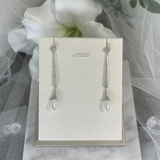 Karla Drop Diamanté with Pearl Earrings (Silver): Luxurious silver-plated earrings featuring a blossom design with rhinestones and a dangling pearl, perfect for weddings and special occasions.