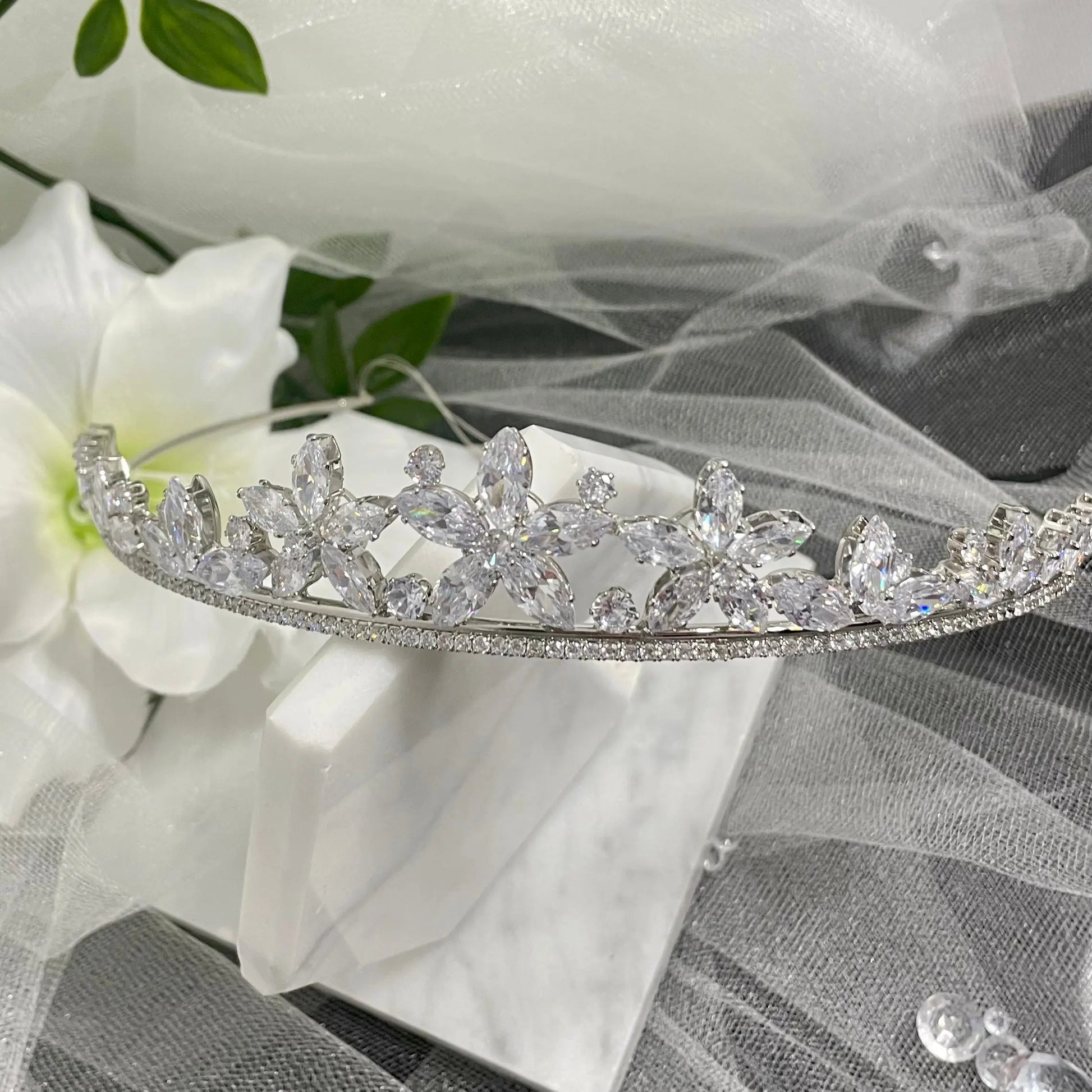 Katty Floral Crystal Headpiece Tiara, featuring elegant flower-like crystals and scattered CZs, perfect for adding a touch of regal elegance to any special occasion outfit.