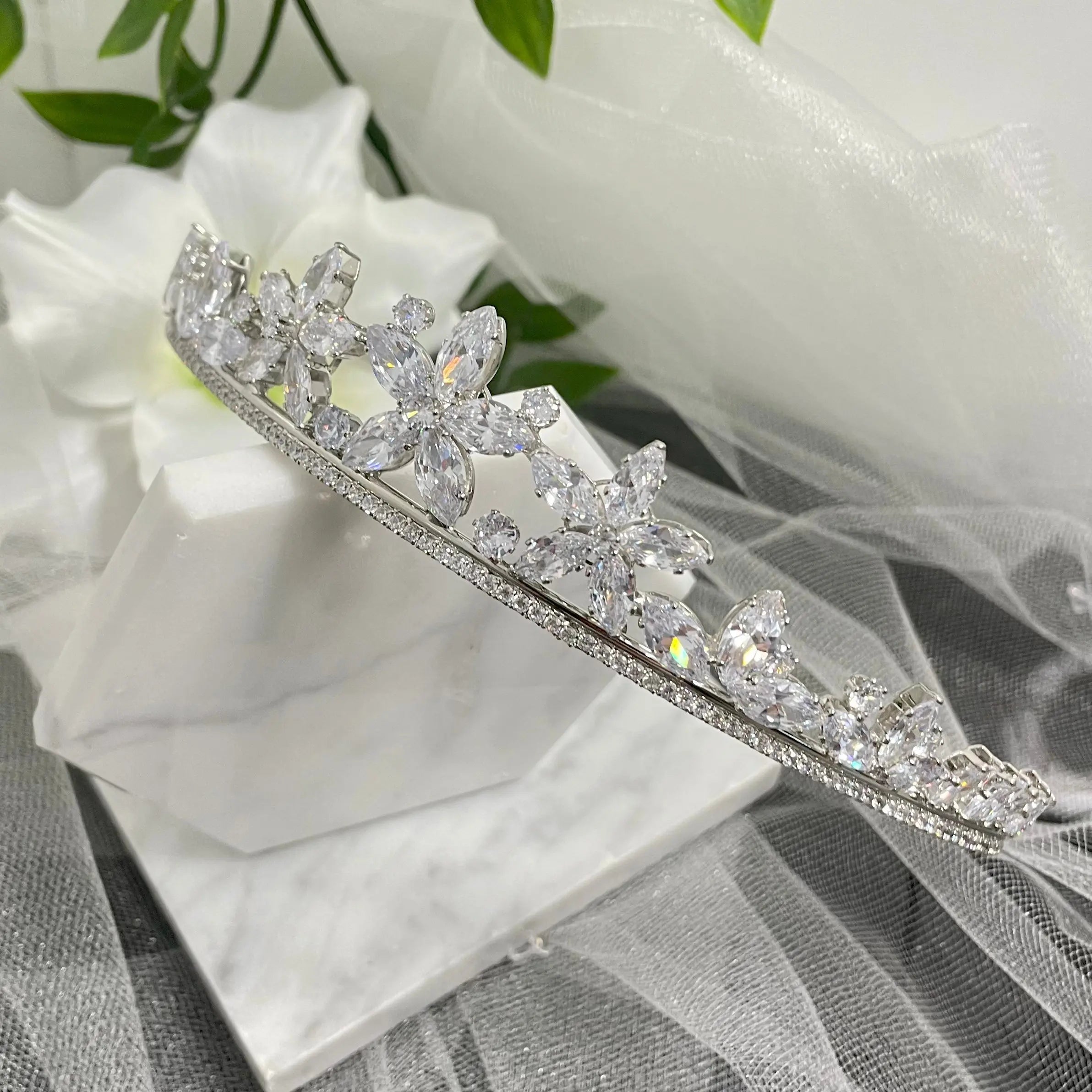 Katty Floral Crystal Headpiece Tiara, featuring elegant flower-like crystals and scattered CZs, perfect for adding a touch of regal elegance to any special occasion outfit.