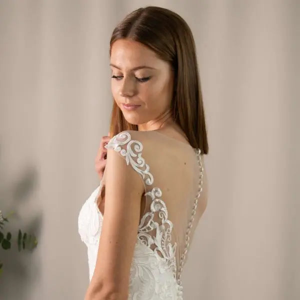 Kayce Wedding Dress Bodice Close-Up: Close-up of the back bodice of the Kayce Wedding Dress, highlighting the lace detailing and sparkling beads.