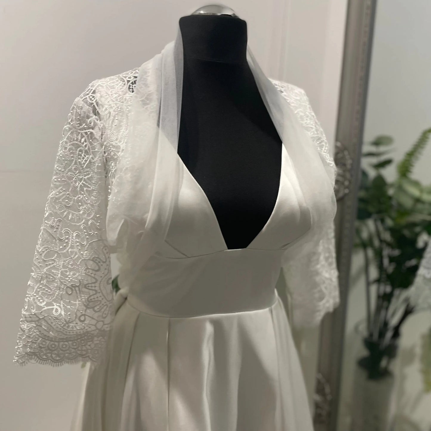 Front view of the Keira wedding bridal bolero jacket, showcasing the delicate lace and sheer fabric, perfect for a refined bridal look.