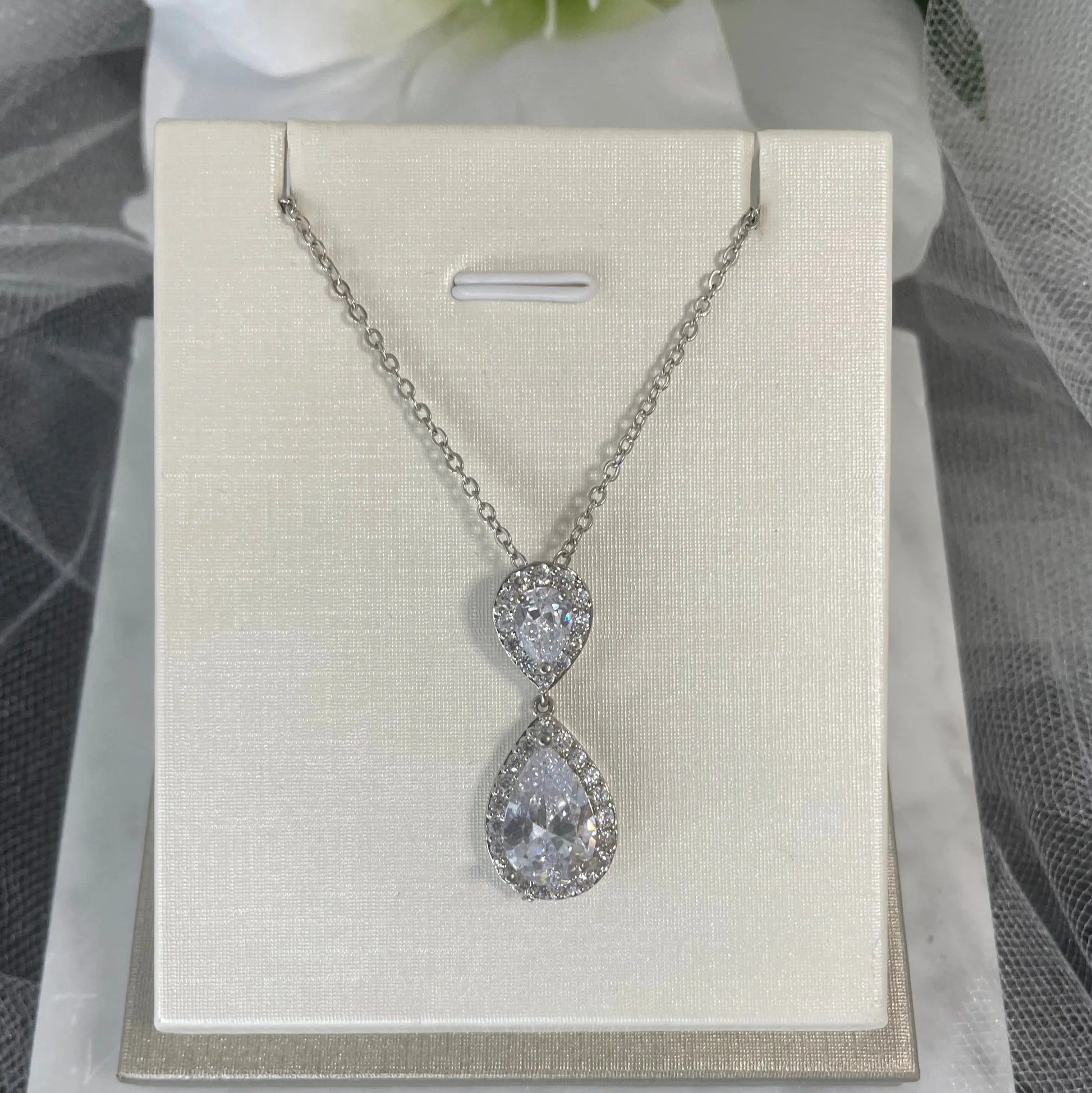 Leona Necklace (Silver): A beautiful silver necklace featuring a large CZ stone surrounded by smaller CZs, with a 45.5 cm chain.
