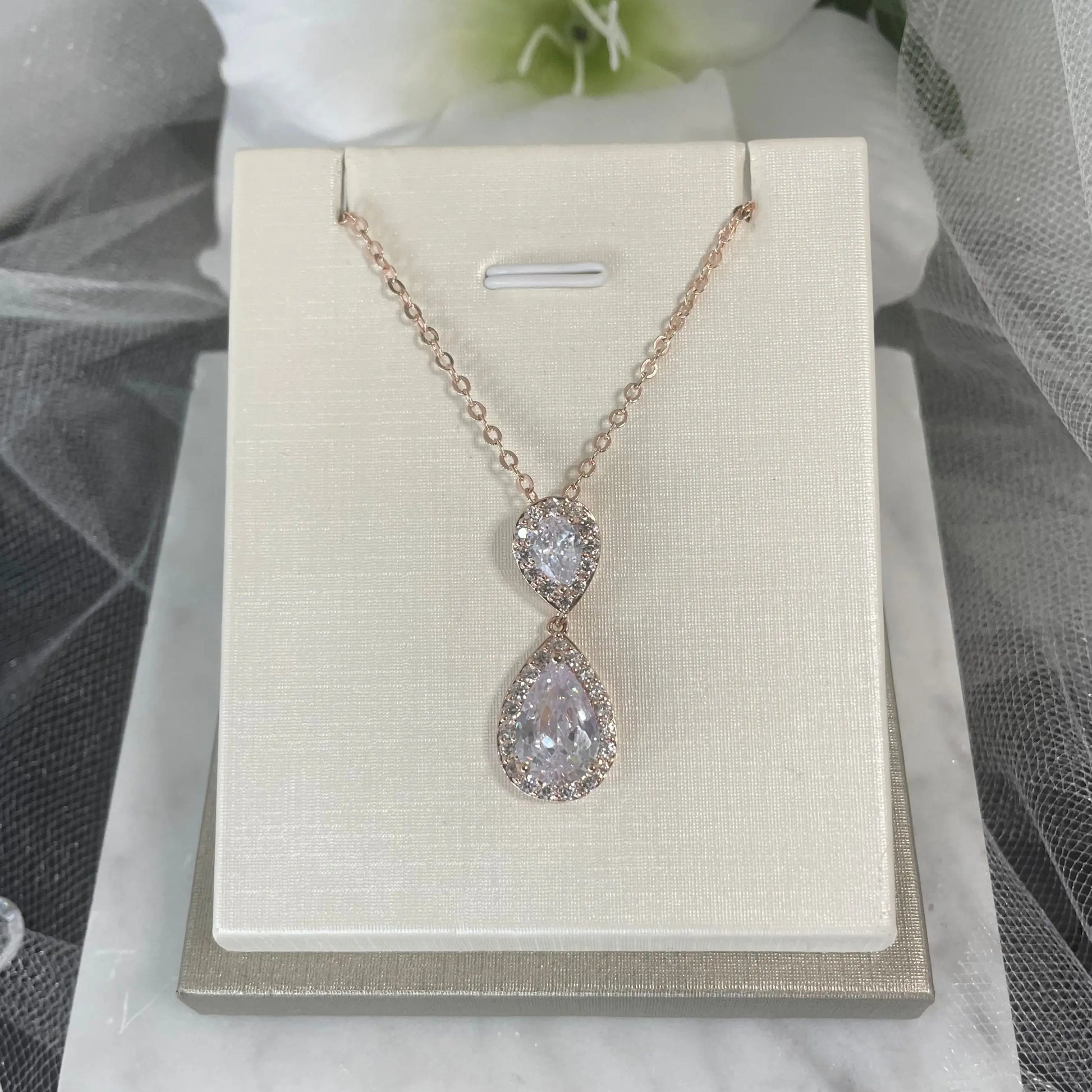 Leona Necklace (Rose Gold): A gorgeous rose gold necklace featuring a large CZ stone surrounded by smaller CZs, with a 45.5 cm chain.