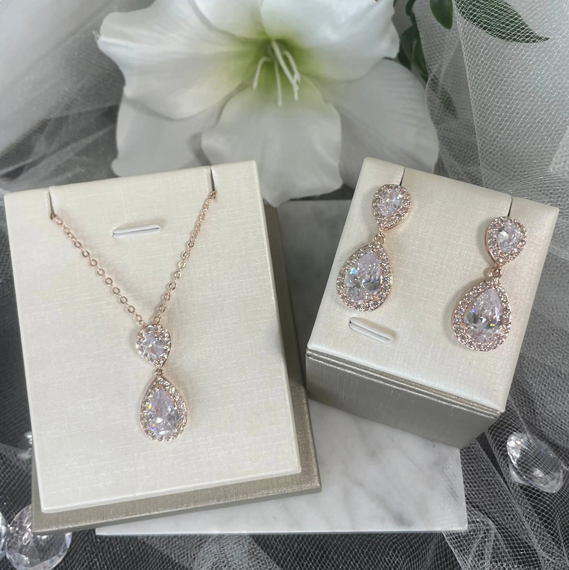 Leona Necklace & Earring Set (Rose Gold): A stunning rose gold necklace and earring set featuring large CZ stones surrounded by smaller CZs.