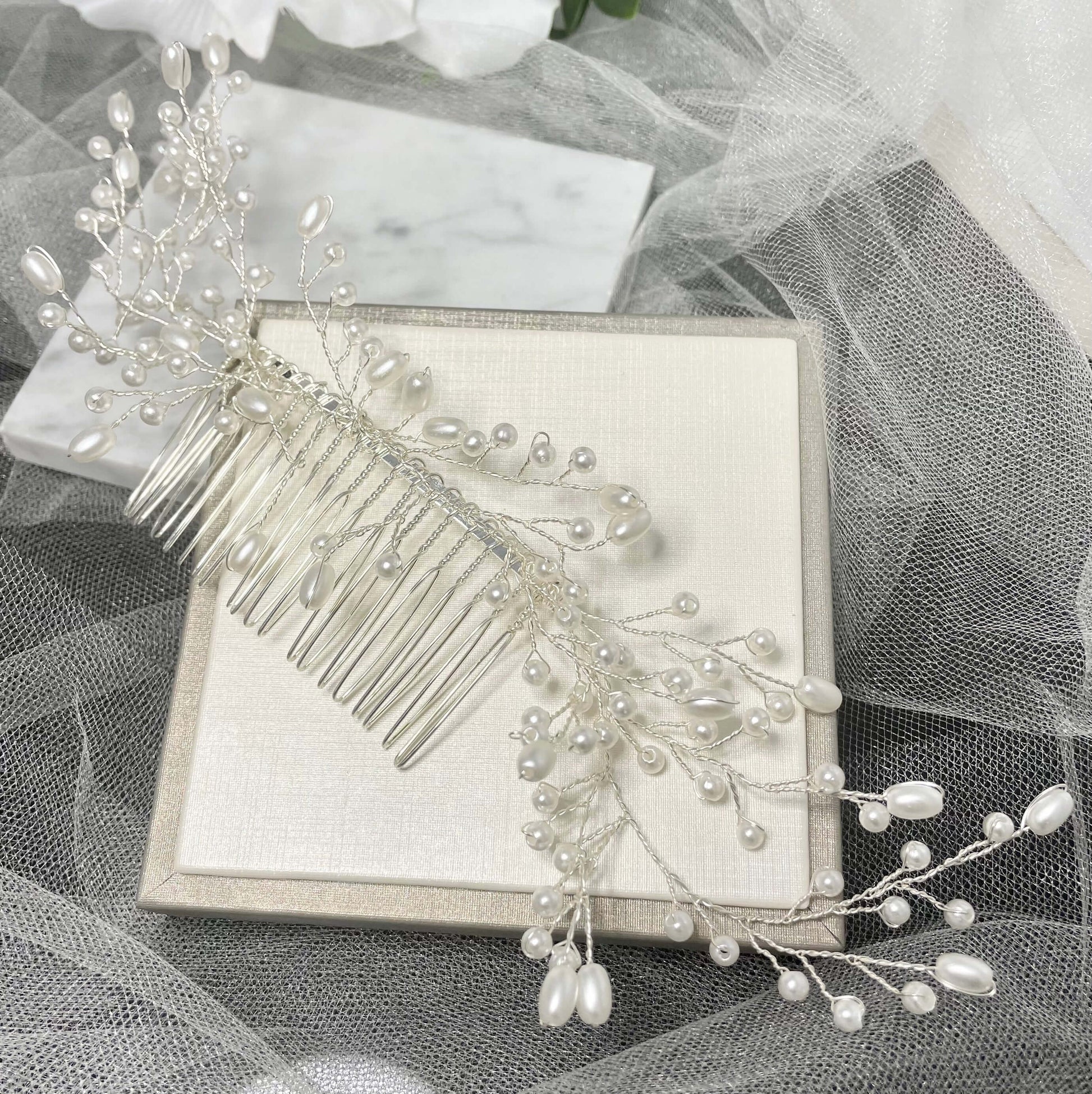 LUCIANA Handmade Pearl Hair Comb featuring delicate pearls and intricate design, measuring approximately 23 cm by 4 cm, perfect for weddings and special occasions.