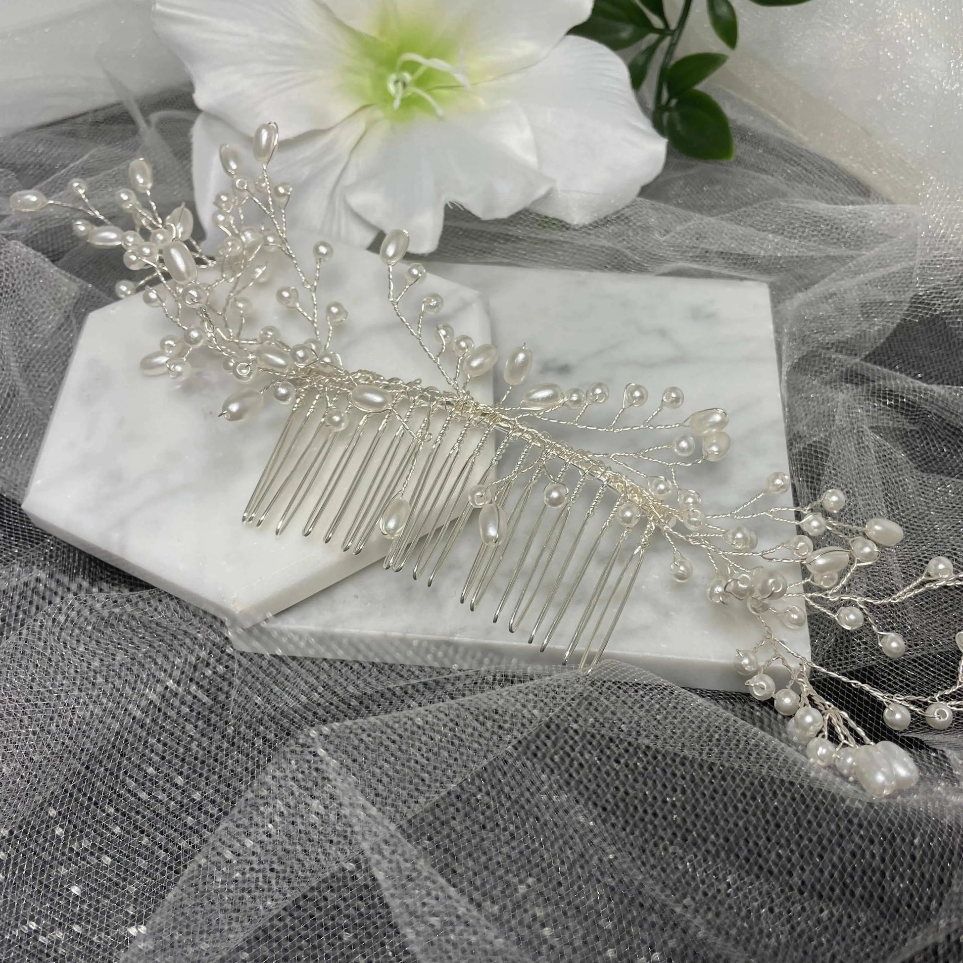 LUCIANA Handmade Pearl Hair Comb featuring delicate pearls and intricate design, measuring approximately 23 cm by 4 cm, perfect for weddings and special occasions.