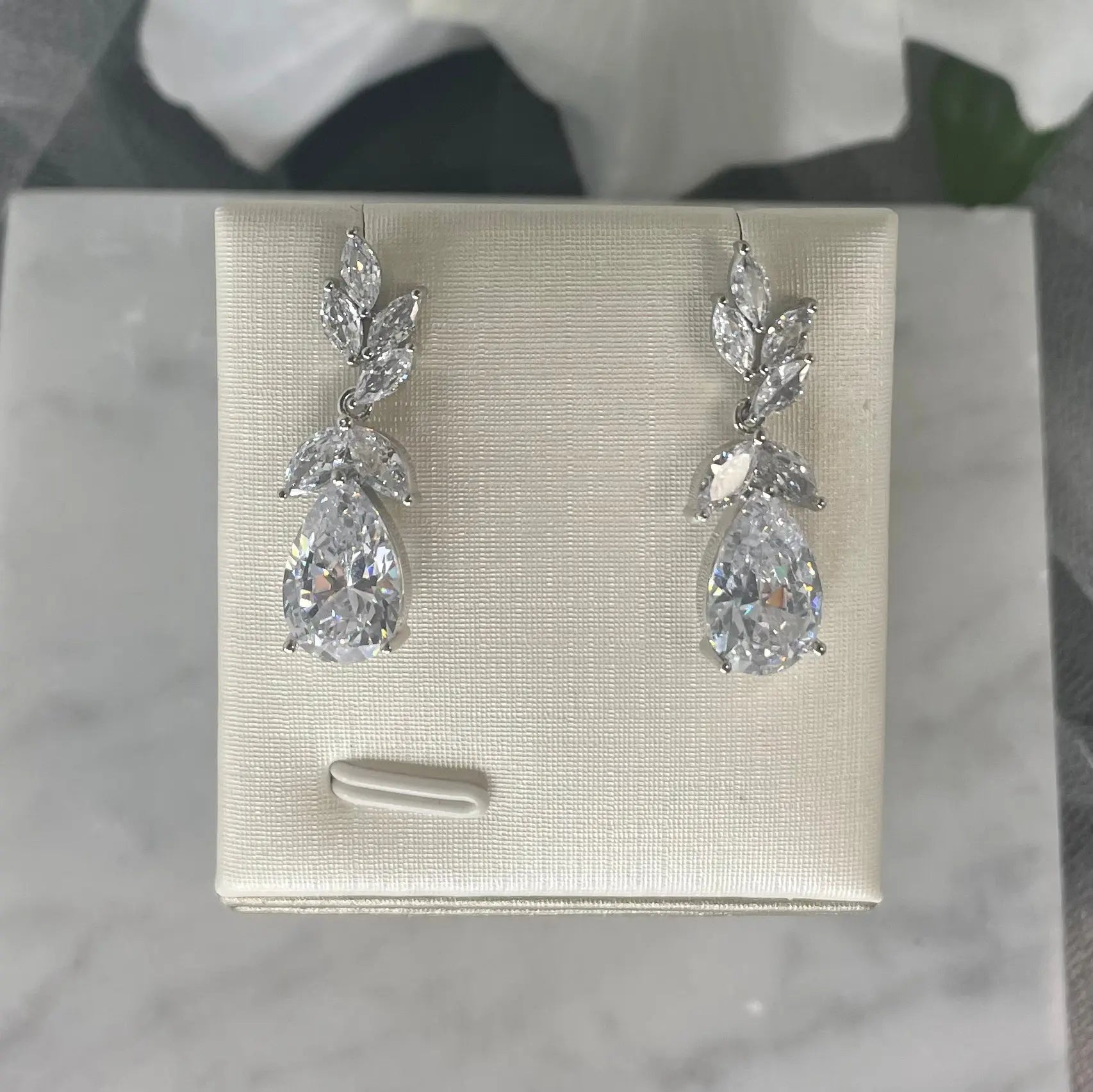 Maisie Earrings on Display: A photo of the Maisie CZ Drop Bridal Wedding Earrings elegantly displayed, highlighting their luxurious and sophisticated look.