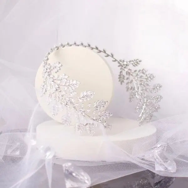 Stunning Mayla Bridal Tiara featuring dazzling marquise solitaire crystals set in a leaf and flower asymmetric pattern, crafted in elegant silver to enhance any bridal look.