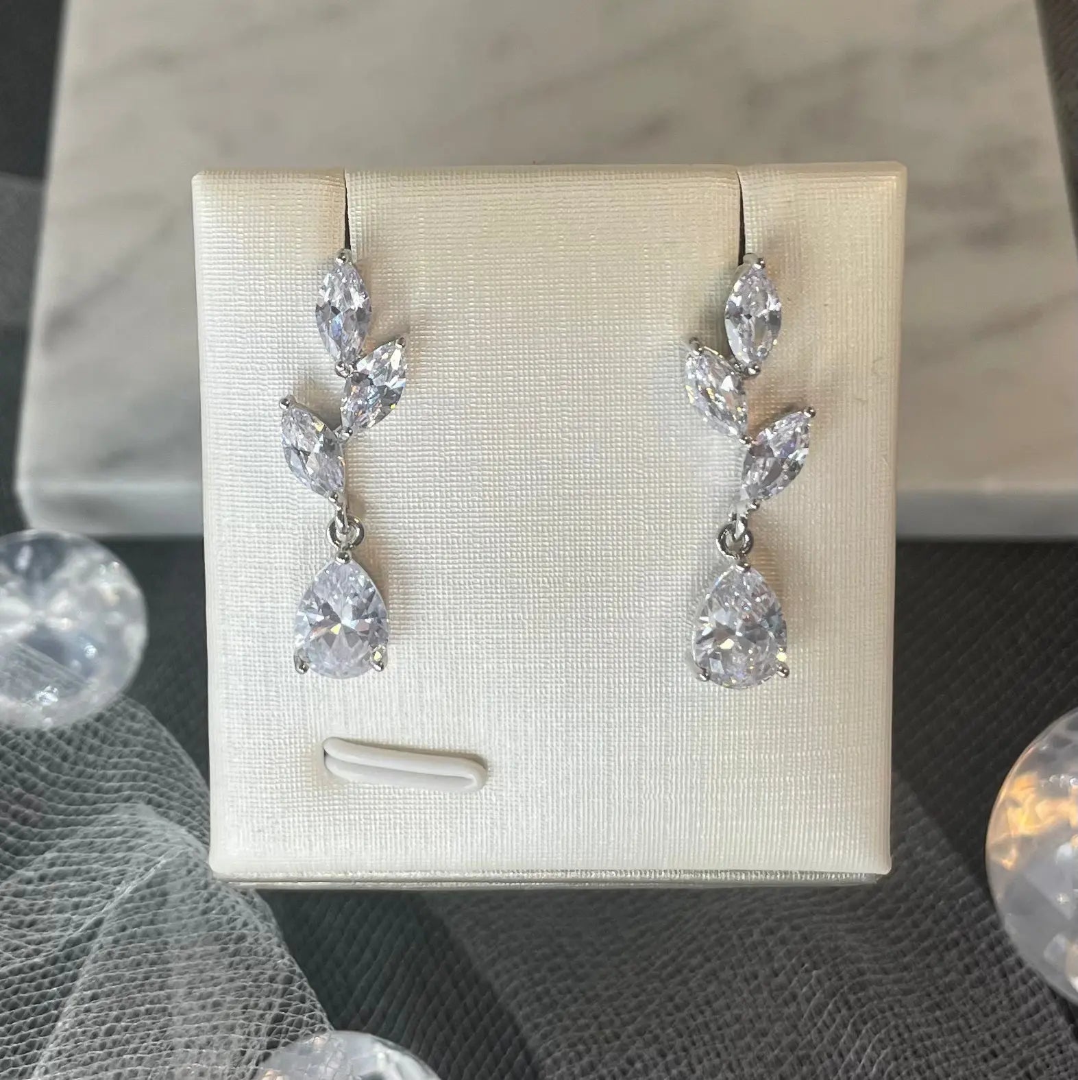 Millie Earrings on Display: A photo of the Millie Water Drop Leaf Bridal Wedding Earrings elegantly displayed, highlighting their luxurious and sophisticated look.