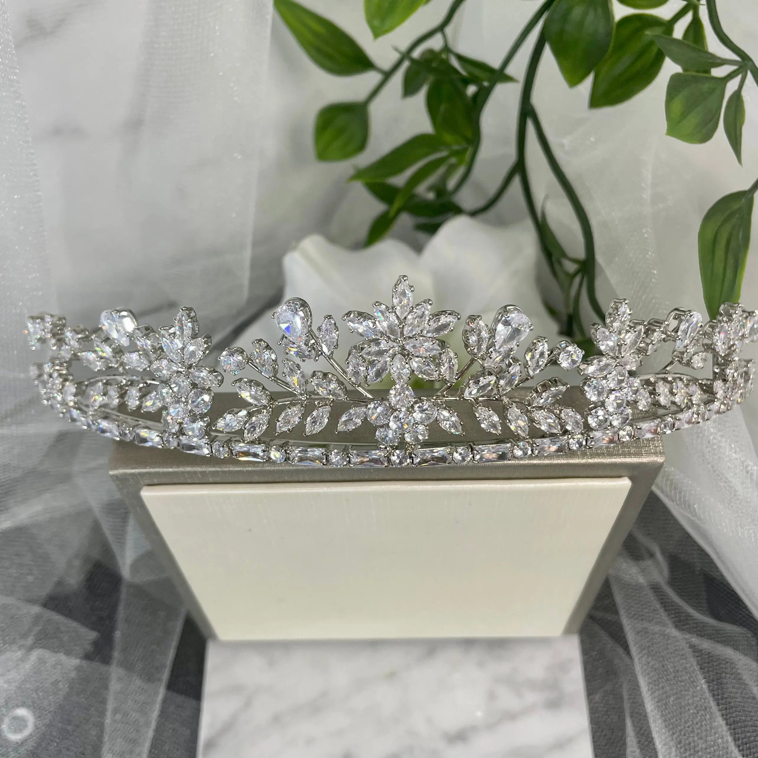 Nia Rhinestone Crystal Bridal Wedding Tiara in Silver, featuring an elegant design of diamanté crystals in floral and leaf patterns, perfect for enhancing a modern bride's look.