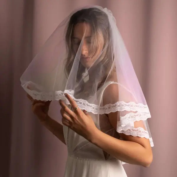 Paula Lace Trim Veil with intricate lace detailing on American tulle, creating a unique and elegant bridal accessory.