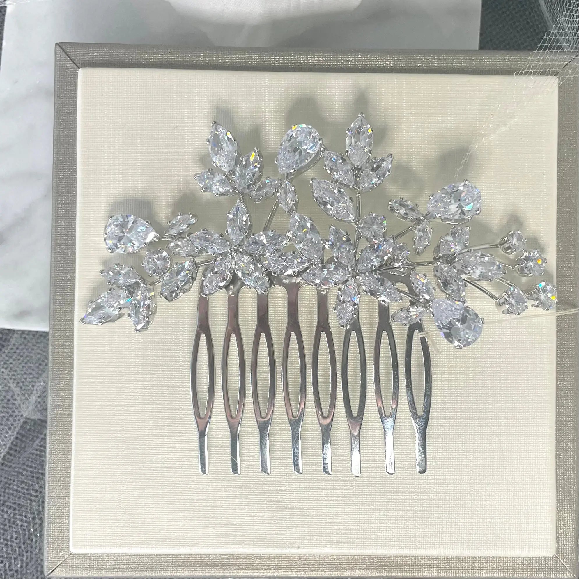 Quilla Bridal Wedding Hair Comb in silver, adorned with CZ crystals in a floral design, ideal for adding elegant sophistication to any bridal hairstyle.