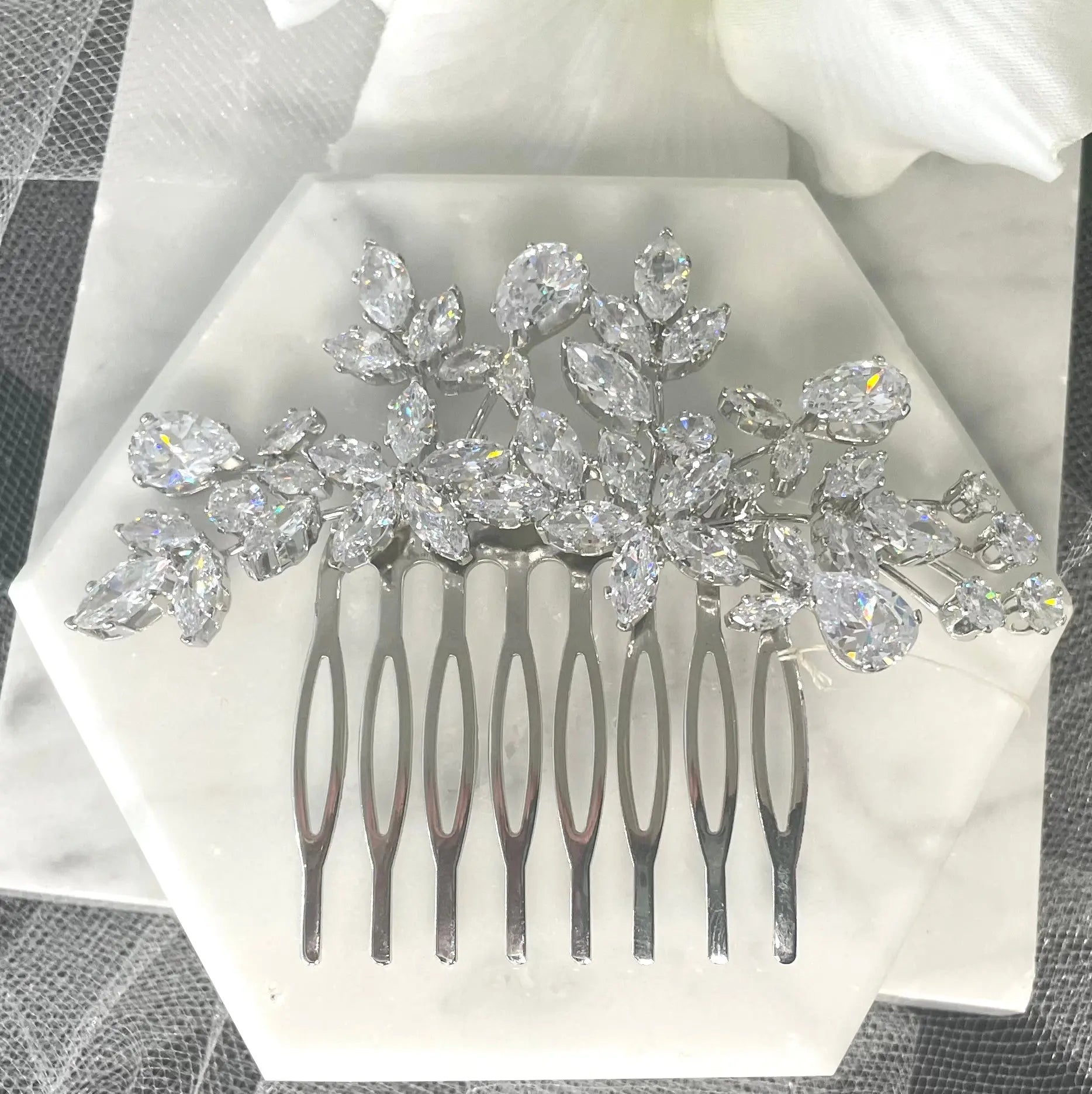 Quilla Bridal Wedding Hair Comb in silver, adorned with CZ crystals in a floral design, ideal for adding elegant sophistication to any bridal hairstyle.