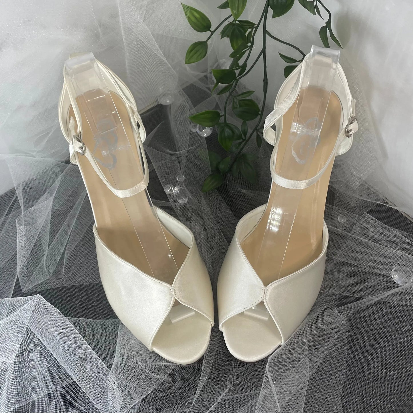 Remi satin bridal shoe with elegant crossover ankle strap.