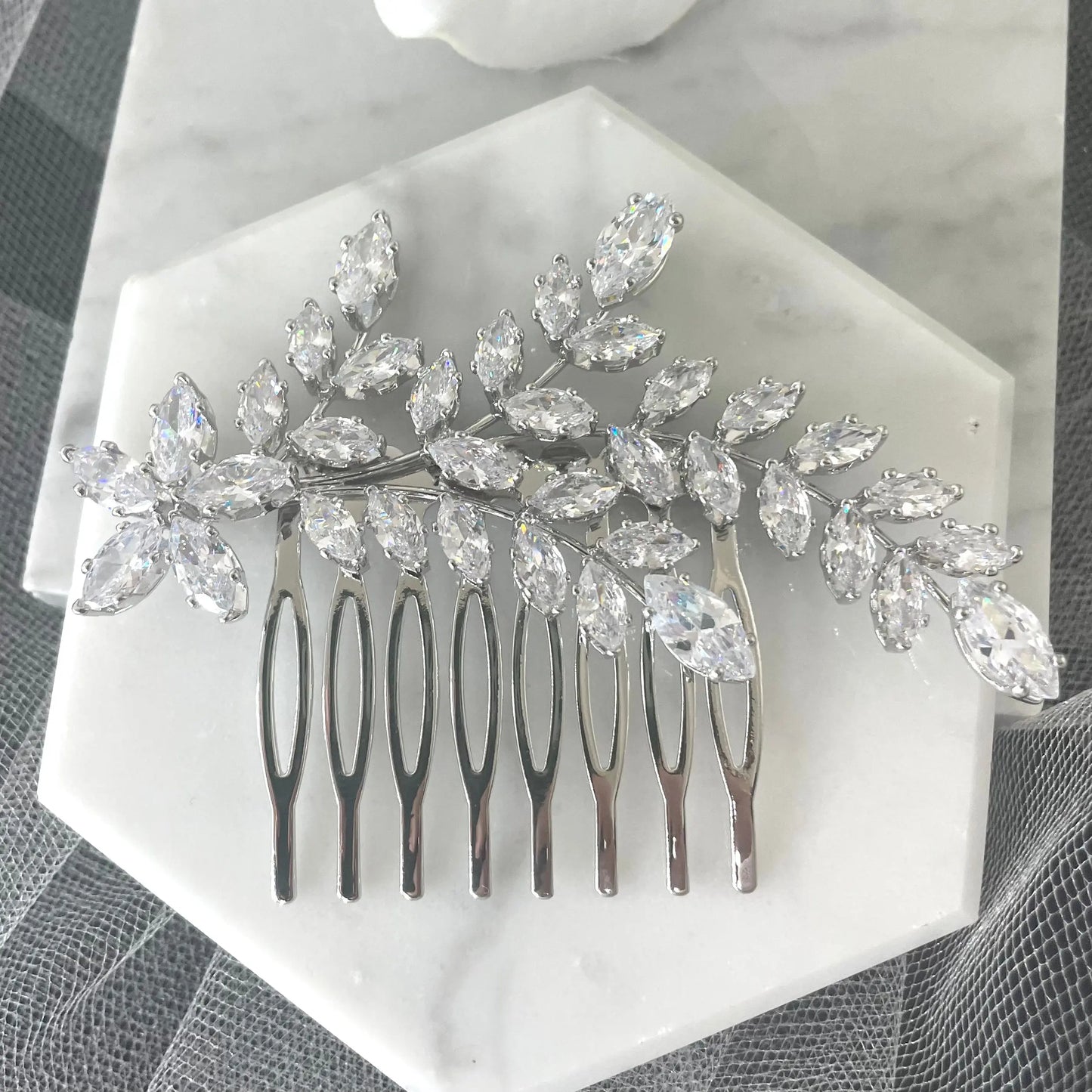 Sophisticated Ross Leaf Bridal Hair Comb in silver, adorned with sparkling marquise crystals, perfect for adding a contemporary and elegant touch to bridal hairstyles.